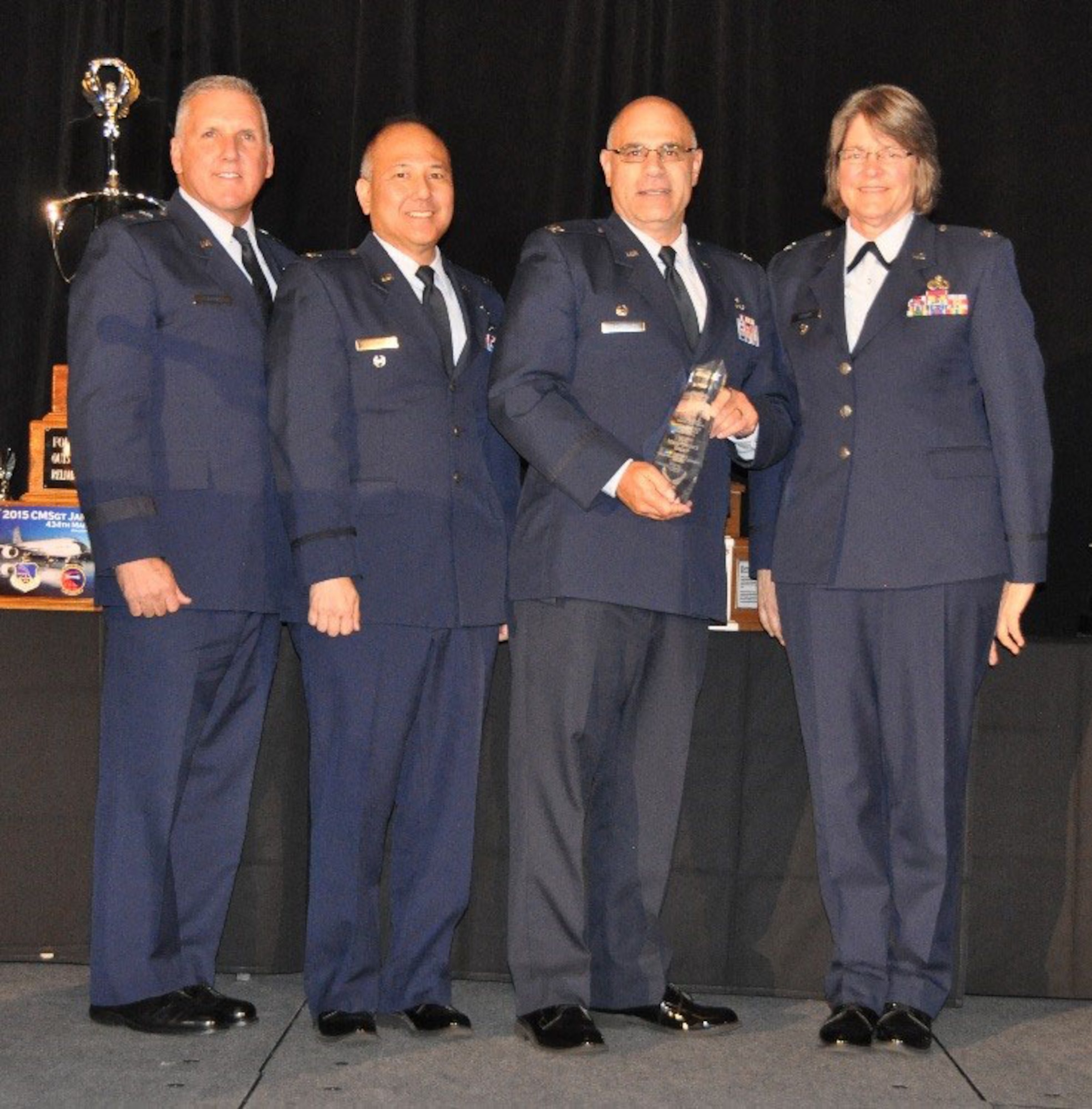 Col. Anthony Espisoto, commander, 514th Maintenance Group, Joint Base McGuire-Dix-Lakehurst, New Jersey, accepts the 2016 Chief Master Sgt. James K. Clouse Award for the best Maintenance Group in 4th Air Force at the 17th Annual Raincross Dinner in Riverside, California, Oct. 20, 2016. From left are Maj. Gen. John C. Flournoy Jr., commander, 4th Air Force; Col. Randall Honke, deputy director, Logistics, 4th Air Force; Esposito; Col. Nancy Brooks, director, Logistics, 4 AF. (U.S. Air Force photo/Linda Welz)