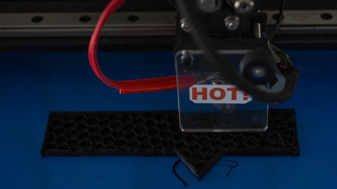 U.S. Marine Corps Chief Warrant Officer 2 Matthew A. Wright, a motor transportation maintenance officer with Marine Wing Support Squadron 372, supervises an Invent3D printer as it creates a Humvee door handle during a 3-D printer integration exercise in support of Weapons and Tactics Instructor  course 1-17 at site 50 training area, Wellton, Arizona, Oct. 18, 2016.  Wright used additive manufacturing equipment to make objects from 3-D model data throughout the WTI course.  WTI is a seven week training event hosted by Marine Aviation Weapons and Tactics Squadron One cadre which emphasizes operational integration of the six functions of Marine Corps aviation in support of a Marine Air Ground Task Force. 