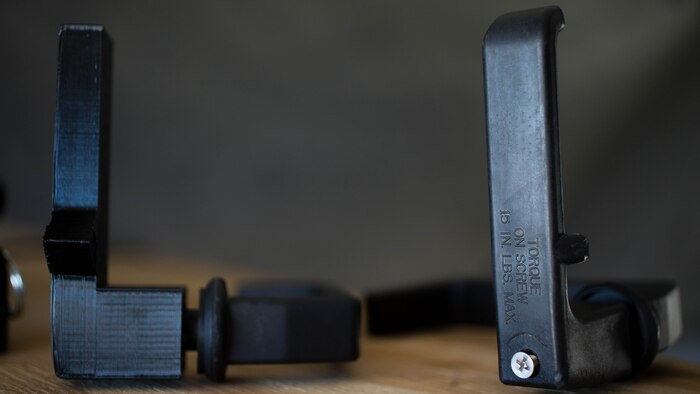 U.S. Marines with Marine Wing Support Squadron 372 use additive manufacturing equipment to make 3-D printed Humvee door handle, left, to replicate an original handle during a 3-D printer integration exercise at site 50 training area, Wellton, Arizona, Oct. 18, 2016. This exercise was part of Weapons Tactics Instructors course 1-17, a seven week training event hosted by Marine Aviation Weapons and Tactics Squadron One cadre which emphasizes operational integration of the six functions of Marine Corps aviation in support of a Marine Air Ground Task Force. MAWTS-1 provides standardized advanced tactical training and certification of unit instructor qualifications to support Marine aviation Training and Readiness and assists in developing and employing aviation weapons and tactics. 