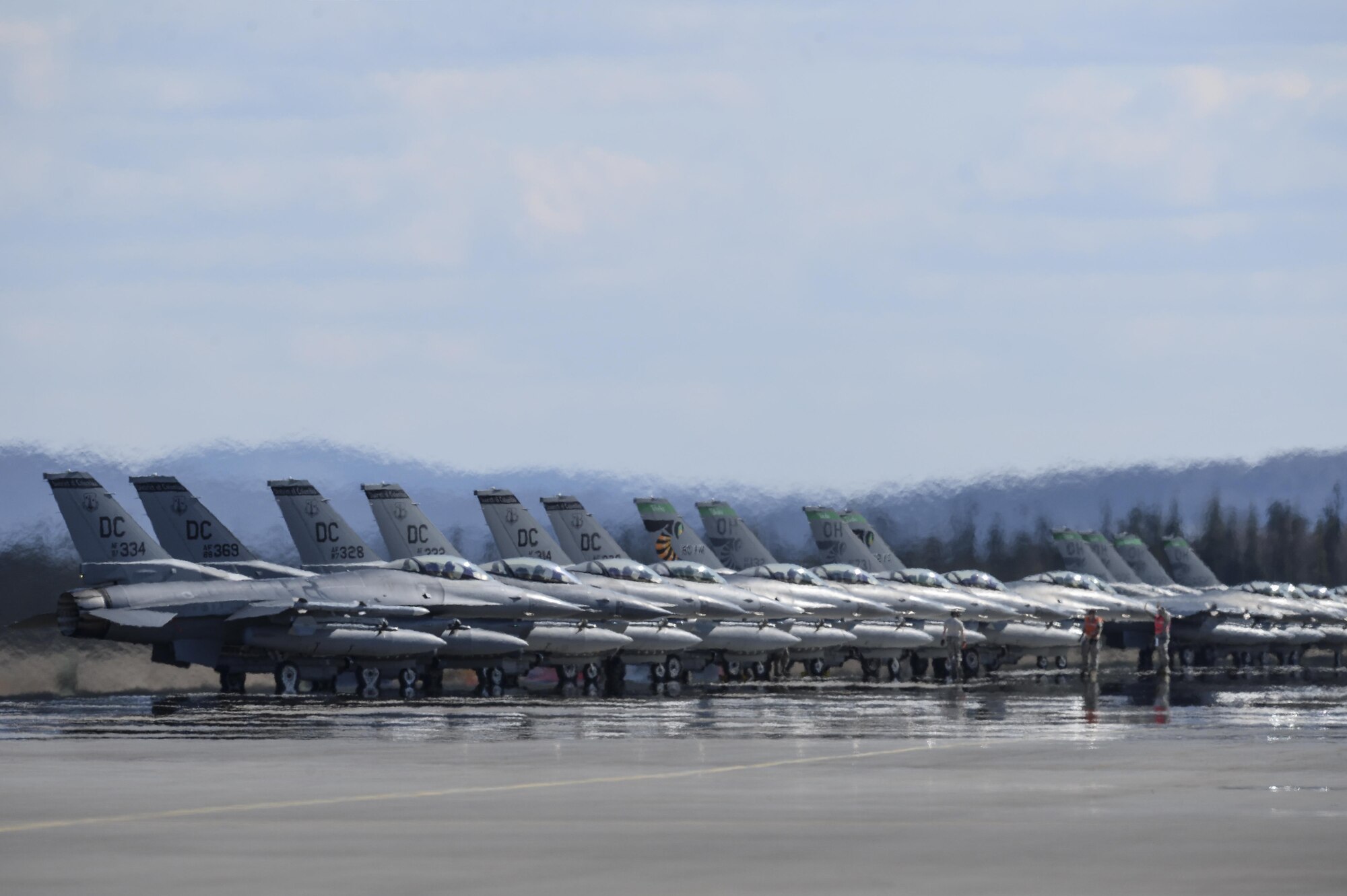 U.S. Air Force F-16 Fighting Falcon aircraft assigned to the 121st Fighter Squadron (FS), Joint Base Andrews, Md., and the 112th FS, Toledo Air National Guard Base, Ohio, stand by for launch May 4, 2015, during RED FLAG-Alaska (RF-A) 15-2 at Eielson Air Force Base, Alaska.  (U.S. Air Force photo by Senior Airman Peter Reft/Released)