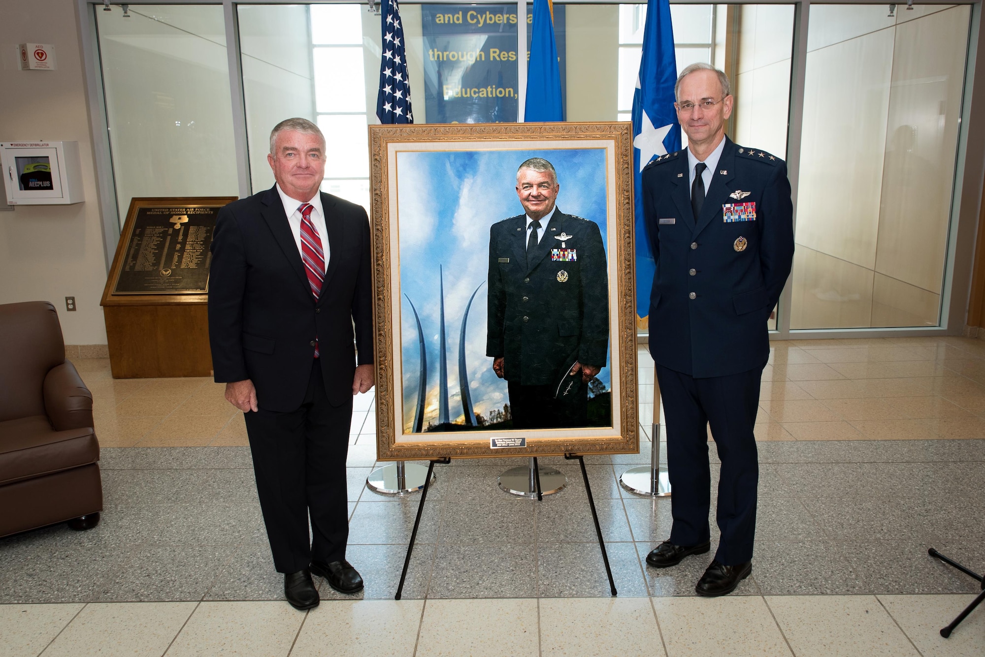 Lt. Gen. (ret) Thomas W. Travis (left), who served as the 21st Surgeon General of the United States Air Force, and Lt. Gen. Mark A. Ediger, current Air Force Surgeon General, unveil a portrait of Travis to hang in the United States Air Force School of Aerospace Medicine during a ceremony here Oct. 24, 2016. The School -- part of the Air Force Research Laboratory's 711th Human Performance Wing -- displays portraits of all past Air Force Surgeons General. Travis served in the role from July 2012 until June 2015, and also served as the School's commander from July 2001 to February 2003. "I'm very, very proud of my history with the School," Travis said at the ceremony, "during my times as a student, my time as commander and my time as the surgeon general. "The School has a bright future, and I look forward to seeing how they continue to accomplish their tremendous mission." (U.S. Air Force photo/Rick Eldridge)