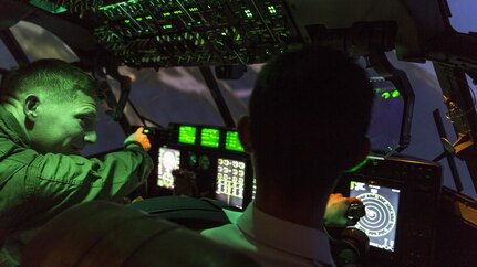 U.S. Marine Corps Capt. Donald Shrewsbury, a KC-130J Hercules representative  with Marine Aviation Training System Site Iwakuni, directs a Japan Air Self-Defense Force aviation cadet with the 12th Flight Training Wing from JASDF Hōfu-kita Air Base while flying a KC-130J simulator during a Japanese officer engagement program at Marine Corps Air Station Iwakuni, Japan, Oct. 19, 2016. The engagement program aims to enhance the understanding and working relationships between U.S. and Japanese pilots. 