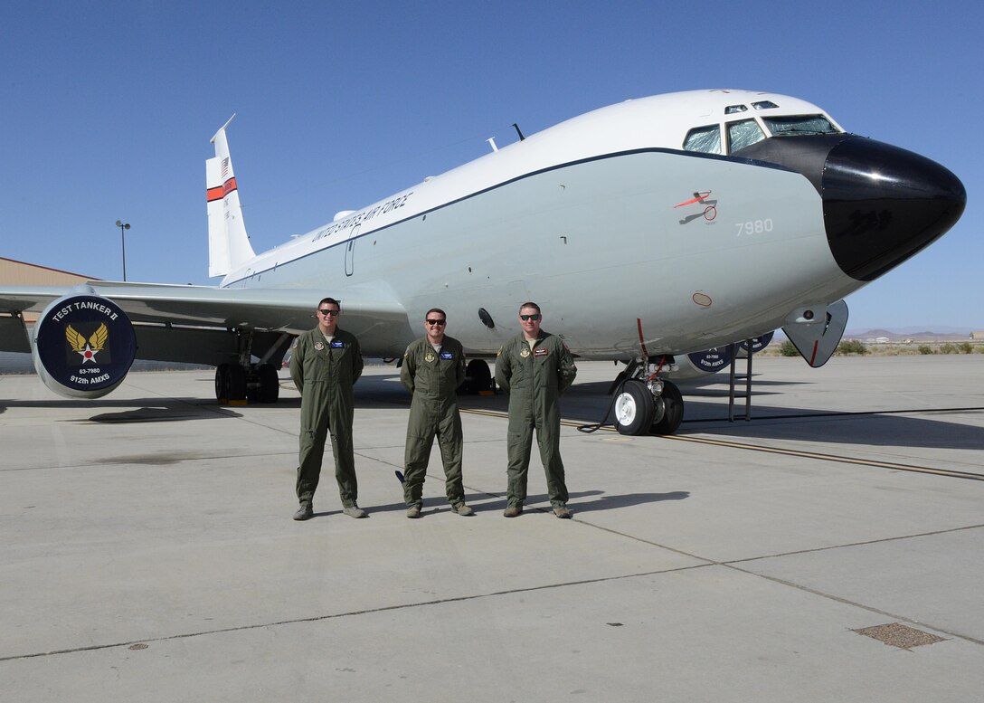 From left to right: Master Sgt. Aaron Ray, Senior Master Sgt. Scott Scurlock, and Tech. Sgt. Colin Wernecke of the 370th Flight Test Squadron pose for a photo in front of a KC-135 Stratotanker test aircraft. (U.S. Air Force photo by Kenji Thuloweit)