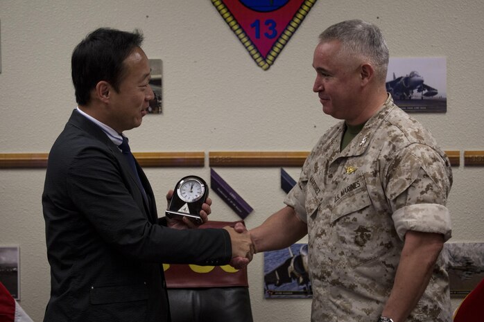Yoshihiko Fukuda, mayor of Iwakuni City, Japan, and U.S. Marine Corps Col. Ricardo Martinez, commanding officer of Marine Corps Air Station (MCAS) Yuma, exchange gifts at MCAS Yuma, Arizona, Oct. 24, 2016. The demonstration of the F-35B gave Fukuda a better understanding of the aircraft and its capabilities. This event helped Fukuda better understand the capabilities of Marine Fighter Attack Squadron (VMFA) 121.(U.S. Marine Corps photo by Cpl. Nathan Wicks)