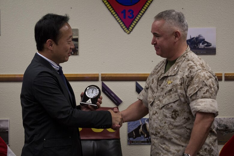 Yoshihiko Fukuda, mayor of Iwakuni City, Japan, and U.S. Marine Corps Col. Ricardo Martinez, commanding officer of Marine Corps Air Station (MCAS) Yuma, exchange gifts at MCAS Yuma, Arizona, Oct. 24, 2016. The demonstration of the F-35B gave Fukuda a better understanding of the aircraft and its capabilities. This event helped Fukuda better understand the capabilities of Marine Fighter Attack Squadron (VMFA) 121.(U.S. Marine Corps photo by Cpl. Nathan Wicks)