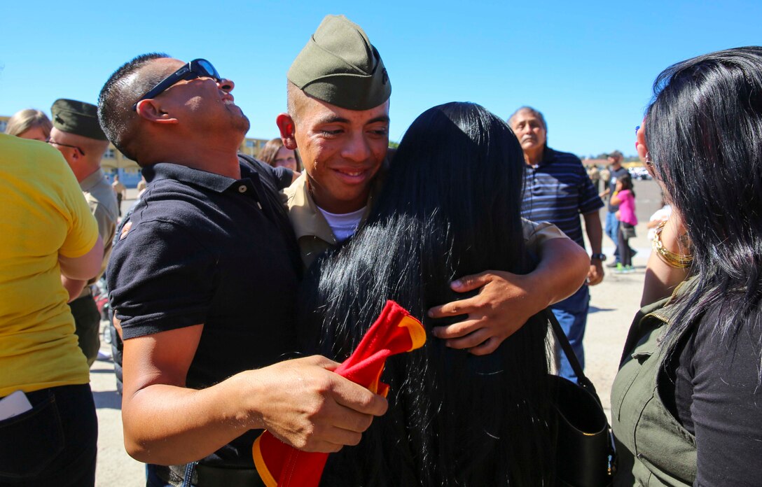 A Marine from Echo Company, 2nd Recruit Training Battalion, hugs his loved ones after being released for liberty at Marine Corps Recruit Depot San Diego, Oct. 20. This is the first time they have seen their Marines since they arrived at the depot 13 weeks ago. Annually, more than 17,000 males recruited from the Western Recruiting Region are trained at MCRD San Diego. Echo Company is scheduled to graduate Oct. 21.