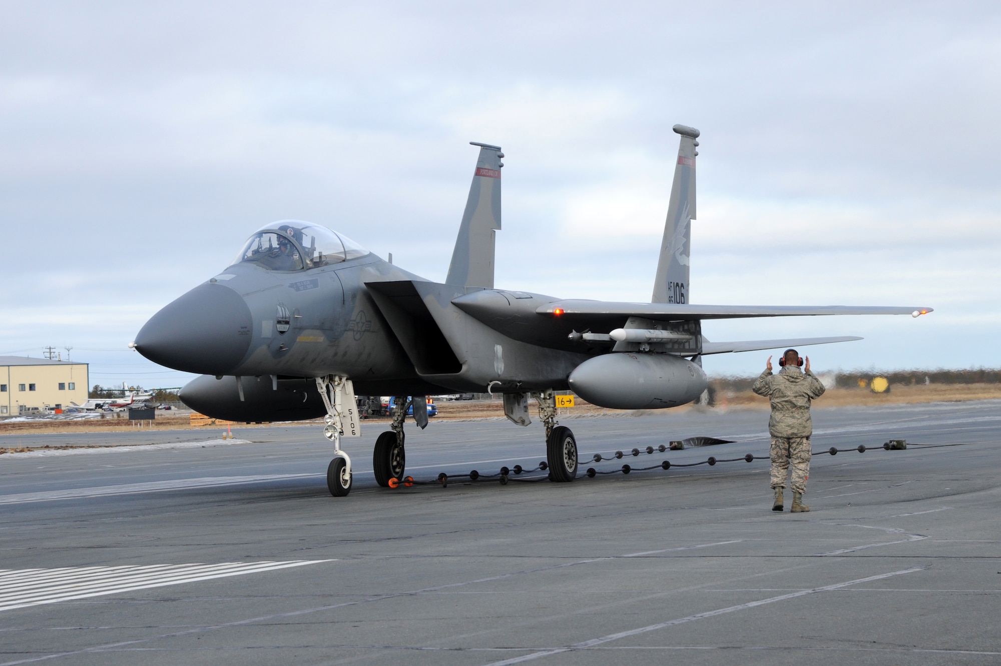 Master Sgt. Dustin Brice, 142nd Maintenance Group, marshals the F-15 Eagle following an aircraft arresting barrier system test at the Yellowknife, Northwest Territories, Airport, Oct. 18, 2016.  The arresting barrier system is used in the event of an emergency where a fighter aircraft cannot stop on its own.  Members of the 142nd Fighter Wing are in Yellowknife to participate in Vigilant Shield 2017. The Vigilant Shield 2017 Field Training Exercise is an annual exercise sponsored by The North American Aerospace Defense Command and led by Alaskan NORAD Region, in conjunction with Canadian NORAD Region and Continental NORAD Region, who undertake field training exercises aimed at improving operational capability in a bi-national environment.   (U.S. Air National Guard photo by Senior Master Sgt. Shelly Davison, 142nd Fighter Wing Public Affairs)