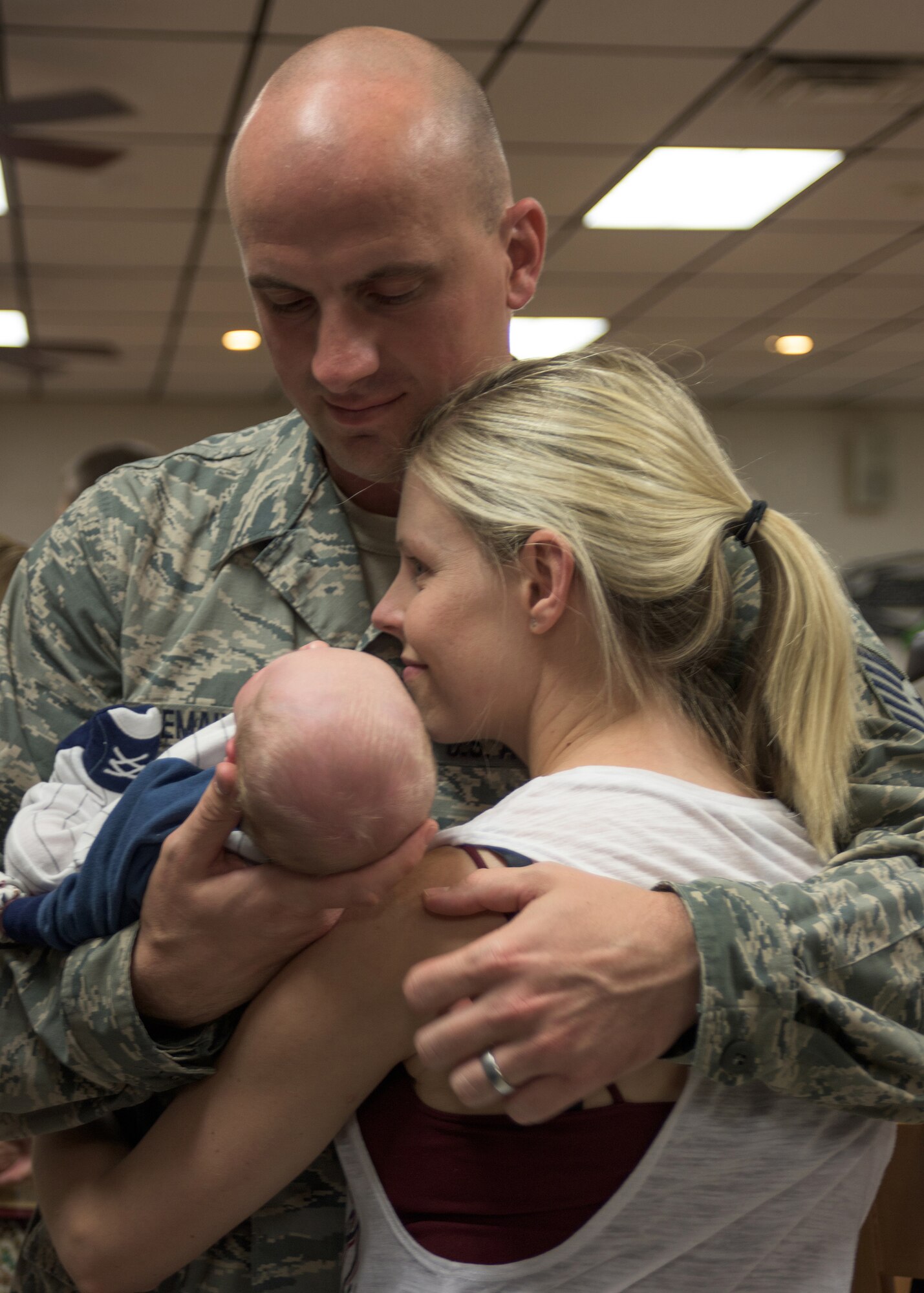 Tech. Sgt. Josh Tremain assigned to the 137th Special Operations Communication Flight, holds his 4-week old baby boy prior to deploying from Will Rogers Air National Guard Base, October 19, 2016. Tremain is one of over 140 Airmen who will deploy from WRANGB in support of Operations Freedom's Sentinel in Southwest Asia, the first major deployment for the 137 SOW as a special operations wing. (U.S. Air National Guard photo by Tech. Sgt. Caroline Essex)