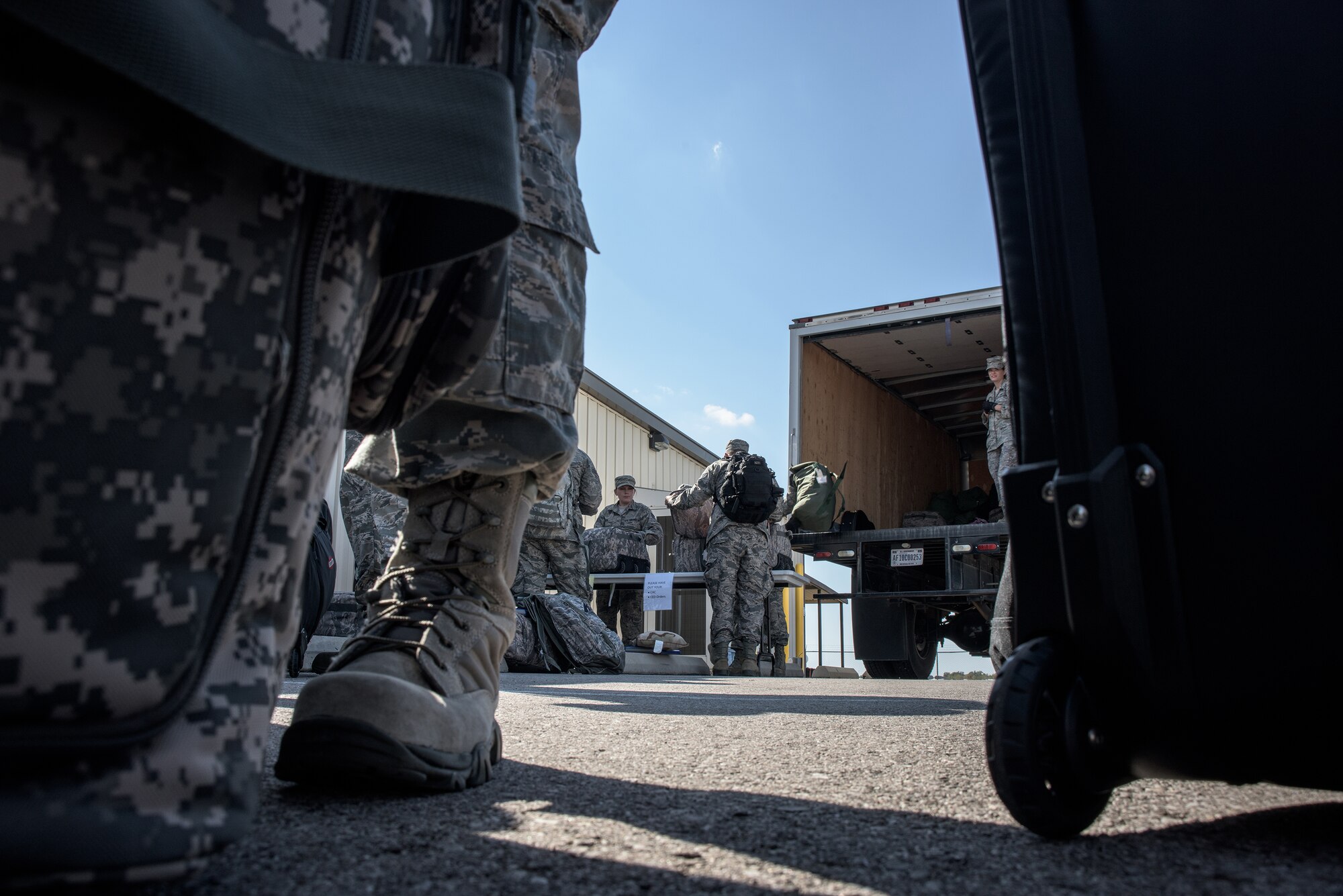 Airmen from the 137th Special Operations Wing, Will Rogers Air National Guard Base, wait for their baggage to be inspected and loaded prior to deploying in Support of Operation Freedom's Sentinel, October 19, 2016. Over 140 Airmen will deploy from WRANGB to nine different locations in Southwest Asia, the first major deployment for the 137 SOW as a special operations wing. (U.S. Air National Guard photo by Tech. Sgt. Caroline Essex)