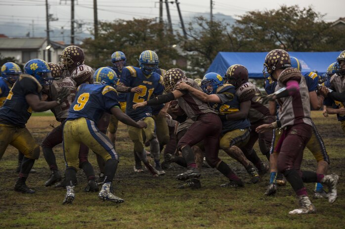 The Matthew C. Perry High School Samurai football team runs the ball against the Yokota High School Panthers during the homecoming football game at Marine Corps Air Station Iwakuni, Japan, Oct. 22, 2016. Both undefeated in Division II Japan, the Samurai (5-1) faced off against the Panthers (4-1) where the winner became the Division II Japan champions. At the end of the fourth quarter, the Samurai beat the Panthers 52-19 making them the Division II Japan champions and will host the Humphreys High School Blackhawks from U.S. Army Garrison, Camp Humphreys, Korea, the Division II Korea champions during the Far East Division II Championship on Nov. 5, 2016. (U.S. Marine Corps photo by Lance Cpl. Aaron Henson)