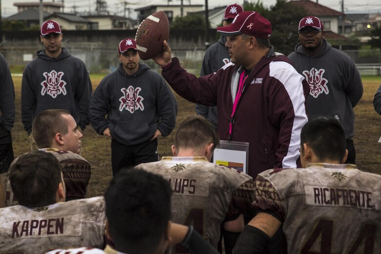 Frank Macias, the Matthew C. Perry High School Samurai football team head coach, talks to players after winning their homecoming football game against the Yokota High School Panthers at Marine Corps Air Station Iwakuni, Japan, Oct. 22, 2016. M.C. Perry dropped their football program in 2004 and are in their third year of varsity after restarting the program in 2014 and M.C. Perry High School will host the Humphreys High School Blackhawks from U.S. Army Garrison, Camp Humphreys, Korea, the Division II Korea champions during the Far East Division II Championship on Nov. 5, 2016. (U.S. Marine Corps photo by Lance Cpl. Aaron Henson)