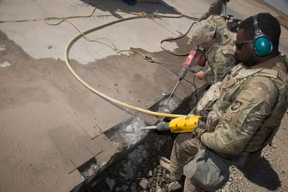 U.S. Air Force Senior Airmen Timothy Williams, assigned to the 1st Expeditionary Civil Engineer Group, operates a jackhammer on a runway during repair operations at Qayyarah, West Airfield, Iraq, Oct. 7, 2016. The runway was destroyed by the Islamic State of Iraq and the Levant (ISIL) destroyed using heavy machinery and explosives. A Coalition of regional and international nations have joined together to enable Iraqi forces to counter ISIL, reestablish Iraq’s borders and re-take lost terrain thereby restoring regional stability and security. (U.S. Army photo by Spc. Christopher Brecht)