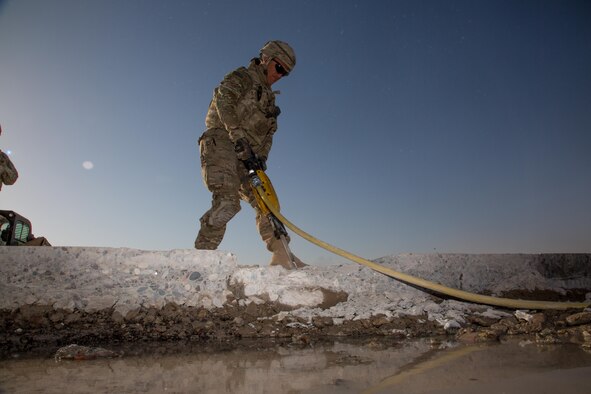A U.S. Airman assigned to the 1st Expeditionary Civil Engineer Group operates a jackhammer during runway repair operations at Qayyarah, West Airfield, Iraq, Oct. 7, 2016. The Islamic State of Iraq and the Levant (ISIL) destroyed the runway using heavy machinery and explosives. A Coalition of regional and international nations have joined together to enable Iraqi forces to counter ISIL, reestablish Iraq’s borders and re-take lost terrain thereby restoring regional stability and security.  (U.S. Army photo by Spc. Christopher Brecht)