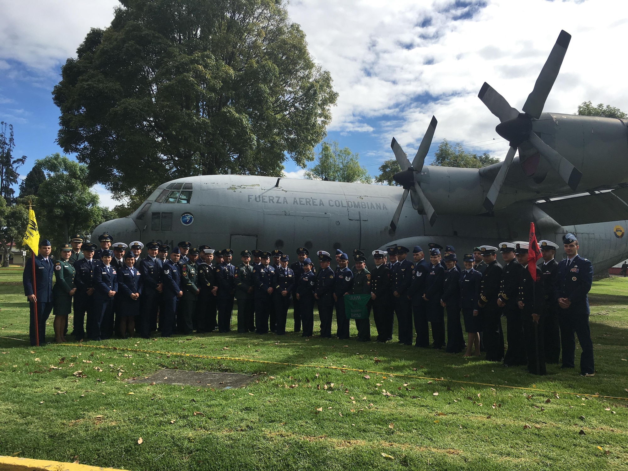 Military members from the United States Air Force and Colombian military stand in front of an aircraft Aug. 25, 2016 at the Colombian Air Mobility Command Headquarters in Bogota, Colombia. The service members recently completed Interamerican Squadron Officer School and the Interamerican Noncommissioned Officer Academy. (Courtesy Photo)