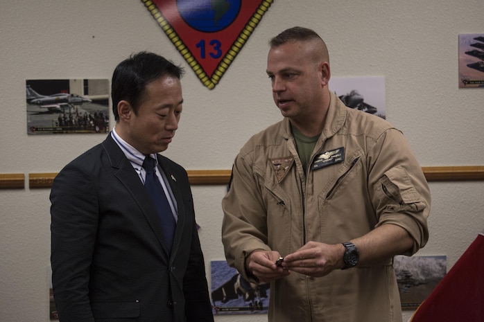 Yoshihiko Fukuda, mayor of Iwakuni City, Japan, and U.S. Marine Corps Col. Marcus Annibale, commanding officer of Marine Aircraft Group (MAG) 13 exchange gifts at Marine Corps Air Station (MCAS) Yuma, Arizona, Oct. 24, 2016. The demonstration of the F-35B gave Fukuda a better understanding of the aircraft and its capabilities. This event helped Fukuda better understand the capabilities of Marine Fighter Attack Squadron (VMFA) 121.(U.S. Marine Corps photo by Cpl. Nathan Wicks)