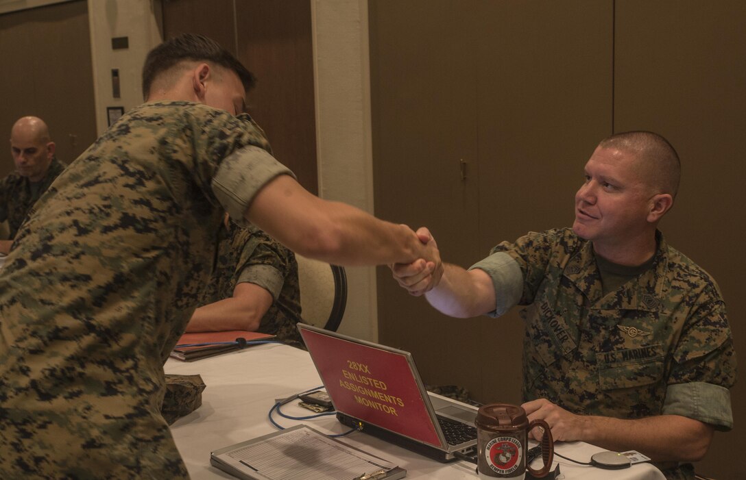 Lance Cpl. Ryan W. Lincoln sits down with Master Sgt. Douglas M. Dickover to discuss his future Marine Corps path on Camp Kinser, Okinawa, Japan, October 25, 2016. The monitors are stationed in Quantico, Virginia, and by flying to Okinawa, they are able to sit down face-to-face with the Marines to enhance the permanent change in station process. “Being able to sit down face to face, I was able to discuss and actually get the duty station I wanted, which was Miramar, California,” said Lincoln a technical controller for 3rd Marine Division, III Marine Expeditionary Force. Dickover is a data/communications maintenance monitor for Manpower Management Division Enlisted Assignments, Headquarters United States Marine Corps. (U.S. Marine Corps photo by Cpl. Jessica Etheridge / Released)