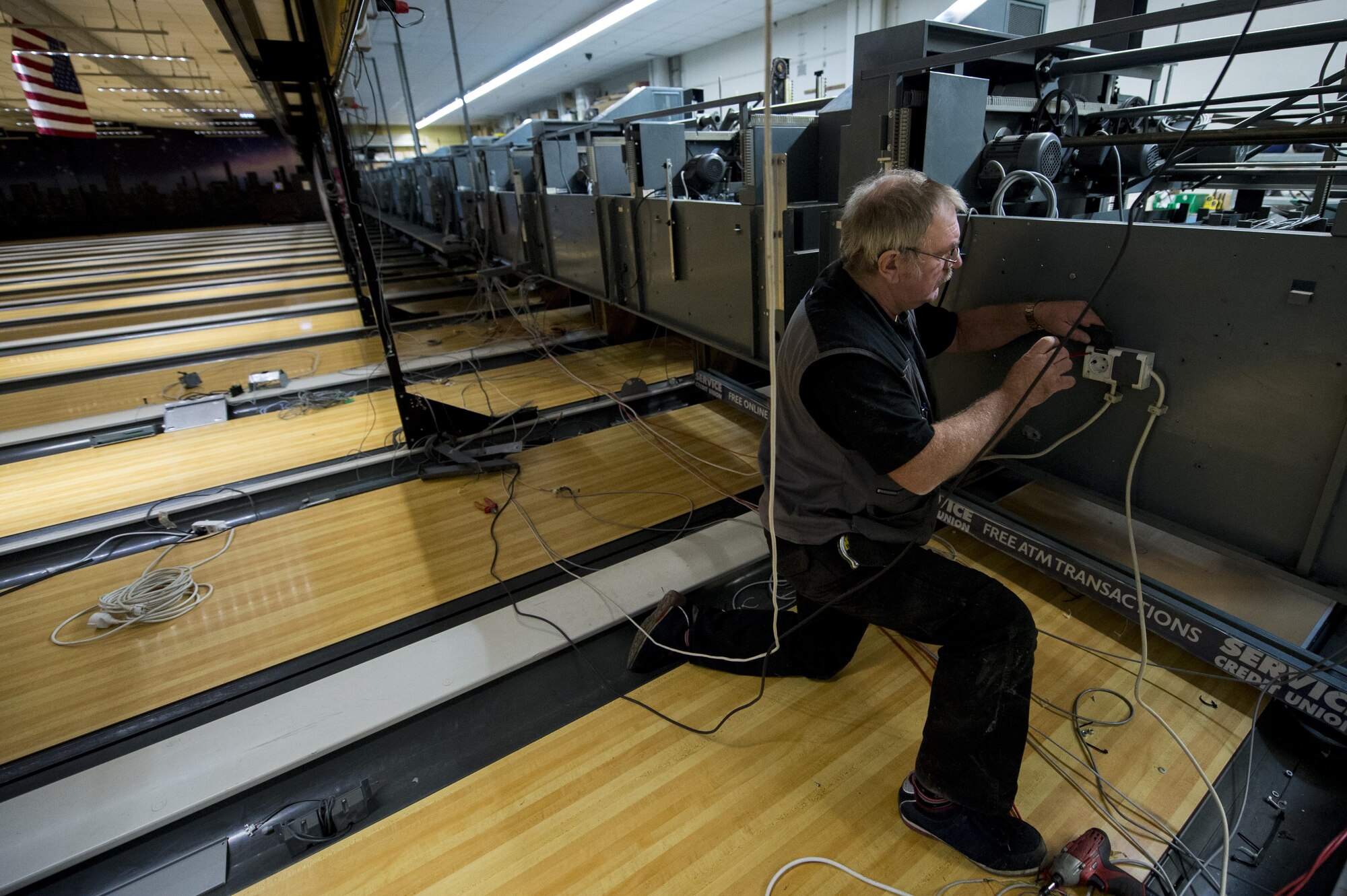 Dave Hardy, a contract worker, disassembles a pin-setter during a renovation at Eifel Lanes bowling center on Spangdahlem Air Base, Germany, Oct. 25, 2016. Renovations, like the bowling alley upgrade, are happening around the base in an effort to improve the quality of life for Airmen and their families. (U.S. Air Force Photo by Airman 1st Class Preston Cherry)