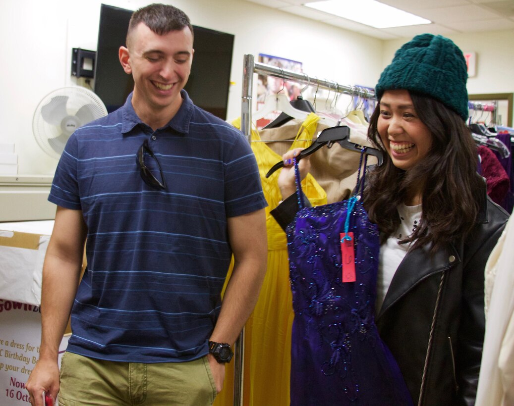 Daniel Ferris and his wife Chikako, are thrilled with the ball gown she found at the ExtravaGOWNza event, where there are donated dresses that spouses get to pick out and take home free.