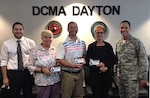 Defense Contract Management Agency Dayton on-time delivery improvement team members Mathew Duguid, Norma Shreves, Gabe Stone and Pam Batlak are honored as Dayton’s team of the quarter by their commander, Air Force Col. Eric Obergfell. The team was celebrated for their continuous process improvement efforts. As the team lead, Duguid had the plaques made for his team as a thank you for their hard work. (DCMA photo by Jason Edem)