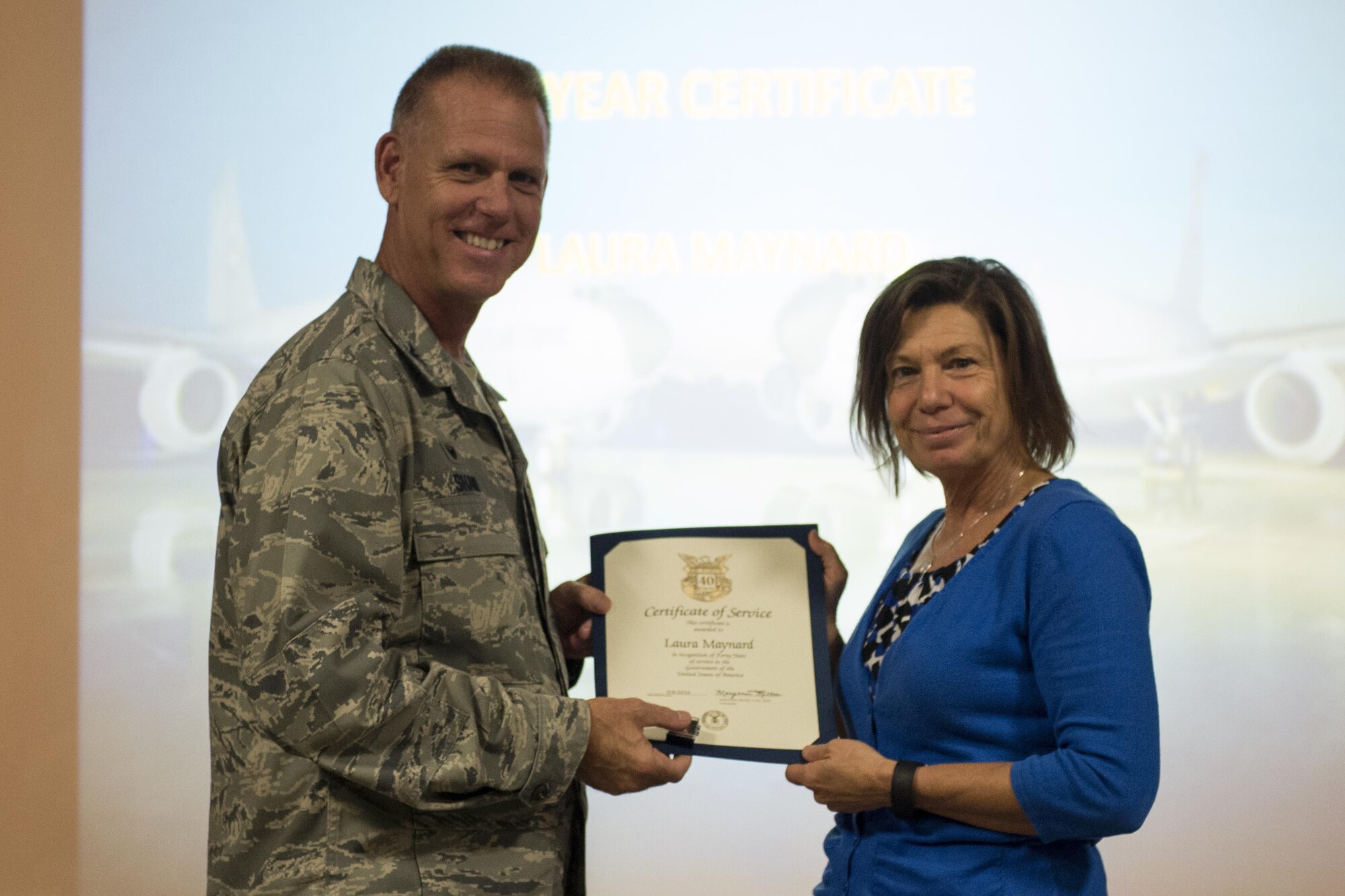 Laura Maynard, 434th Force Support Squadron staffing specialist, right, receives a certificate for 40 years of federal service, at Grissom Air Reserve Base, Ind. Oct. 12, 2016. Maynard was one of several individuals recognized for longevity at a civilian commander’s call. (U.S. Air Force photo/Tech. Sgt. Benjamin Mota)