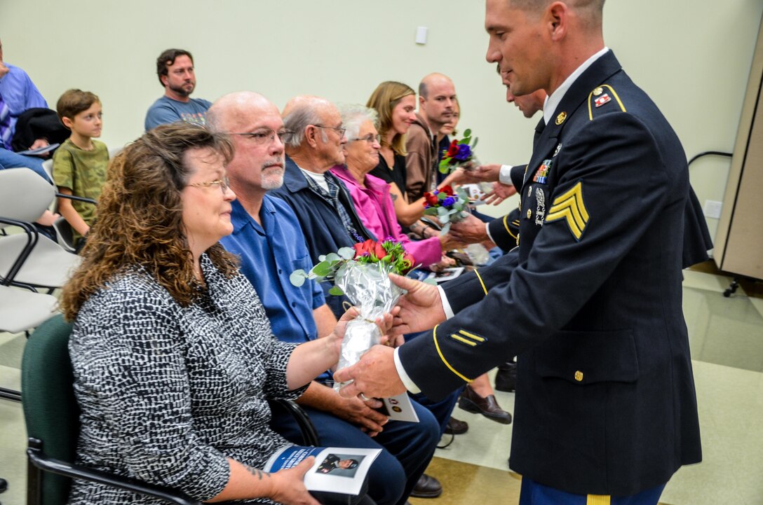 Jan Grothe, mother of the Fallen Soldier, is presented with flowers during the memorialization ceremony of the Cpl. Kelly B. Grothe Army Reserve Center in Hayden, Idaho, Oct. 22. Grothe was a United States Army Combat Engineer assigned to Bravo Company, 321st Engineer Battalion, who was killed in action while conducting route clearance operations in the area of Abu Bali, Iraq during the Global War on Terrorism, May 3, 2007. He was 21 years old.