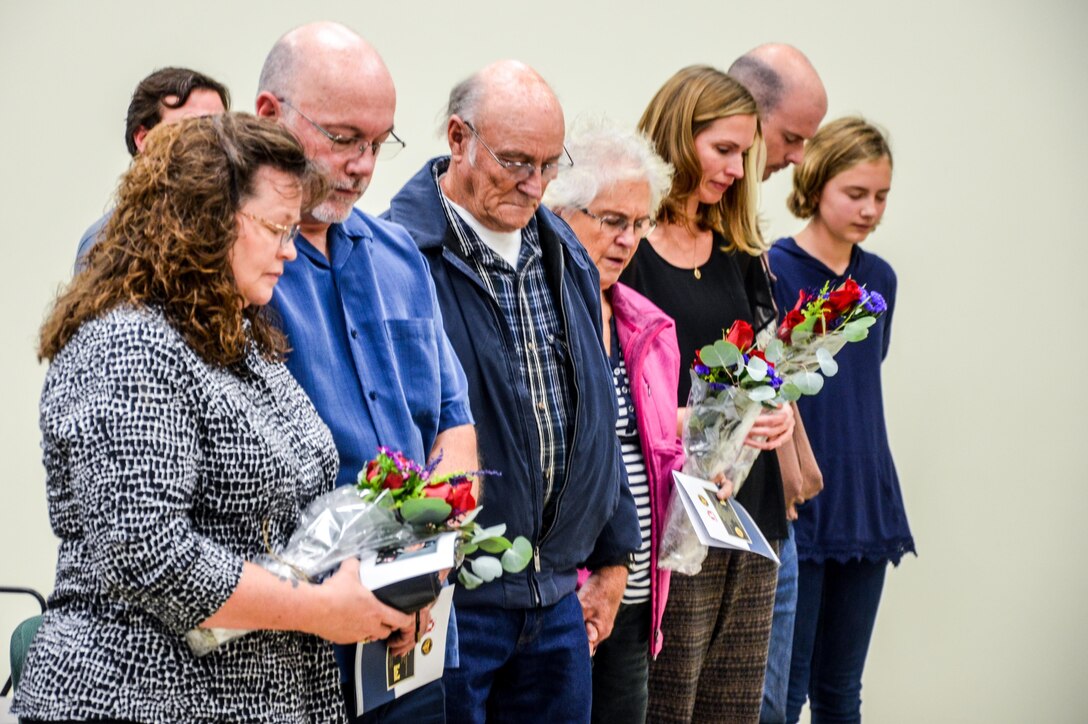 Jan and Brian Grothe, (far left) parents of the Fallen Soldier, along with (left to right) his grandparents, sister and other family members bow their heads during the memorialization ceremony of the Cpl. Kelly B. Grothe Army Reserve Center in Hayden, Idaho, Oct. 22. Grothe was a United States Army Combat Engineer assigned to Bravo Company, 321st Engineer Battalion, who was killed in action while conducting route clearance operations in the area of Abu Bali, Iraq during the Global War on Terrorism, May 3, 2007. He was 21 years old.