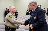 Kootenai County, Idoho Sheriff Ben Wolfinger and U.S. Army Reserve Ambassador, for the state of Washington, Hon. William Fred Aronow, Ret., shake hands before being seated for the memorialization ceremony of the Cpl. Kelly B. Grothe Army Reserve Center in Hayden, Idaho, Oct. 22. Grothe was a United States Army Combat Engineer assigned to Bravo Company, 321st Engineer Battalion, who was killed in action while conducting route clearance operations in the area of Abu Bali, Iraq during the Global War on Terrorism, May 3, 2007. He was 21 years old.