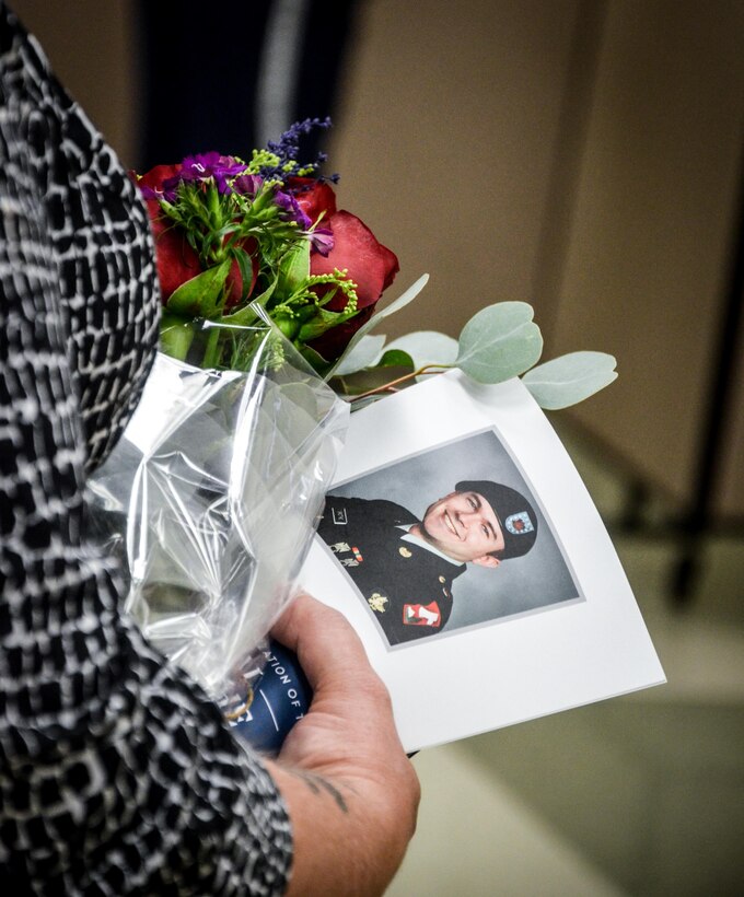 Jan Grothe, mother of the Fallen Soldier, holds a photo of her son during the memorialization ceremony of the Cpl. Kelly B. Grothe Army Reserve Center in Hayden, Idaho, Oct. 22. Grothe was a United States Army Combat Engineer assigned to Bravo Company, 321st Engineer Battalion, who was killed in action while conducting route clearance operations in the area of Abu Bali, Iraq during the Global War on Terrorism, May 3, 2007. He was 21 years old.