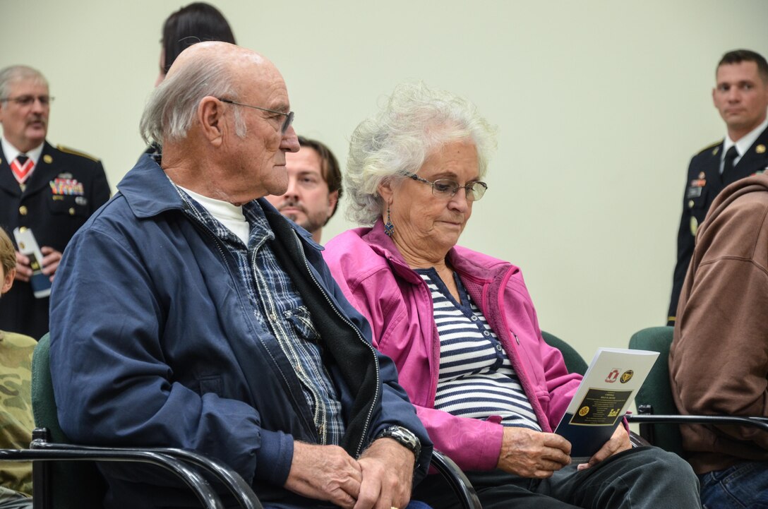 Cpl. Kelly B. Grothe’s grandparents read the dedication program during the memorialization ceremony of the Cpl. Kelly B. Grothe Army Reserve Center in Hayden, Idaho, Oct. 22. Grothe was a United States Army Combat Engineer assigned to Bravo Company, 321st Engineer Battalion, who was killed in action while conducting route clearance operations in the area of Abu Bali, Iraq during the Global War on Terrorism, May 3, 2007. He was 21 years old.