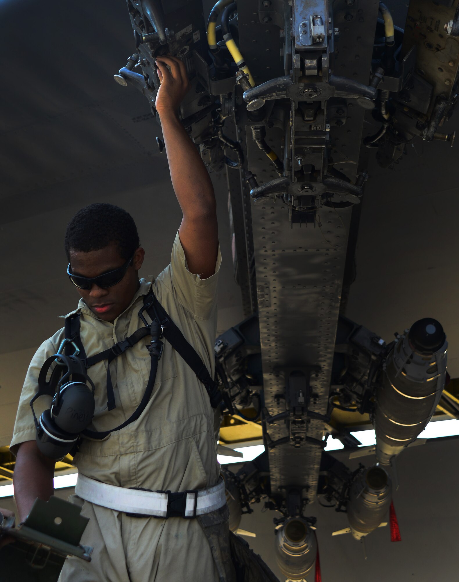 An airman assigned to the 379th Expeditionary Aircraft Maintenance Squadron prepares the weapons rack on an aircraft for loading Oct. 19, 2016. The air operations in support of the offensive to recapture Mosul are conducted as part of Operation Inherent Resolve, the operation to eliminate Da’esh and the threat it poses to Iraq, Syria, the region and wider international community. (U.S. Air Force photo by Senior Airman Miles Wilson)