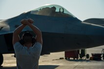 A U.S. Air Force assistant crew chief prepares an F-22 Raptor for take off from an undisclosed location in Southwest Asia, Oct. 20, 2016. F-22 Raptors are one of several coalition airframes providing close air support to ground forces working to liberate the city of Mosul, Iraq. (U.S. Air Force photo by Senior Airman Tyler Woodward)