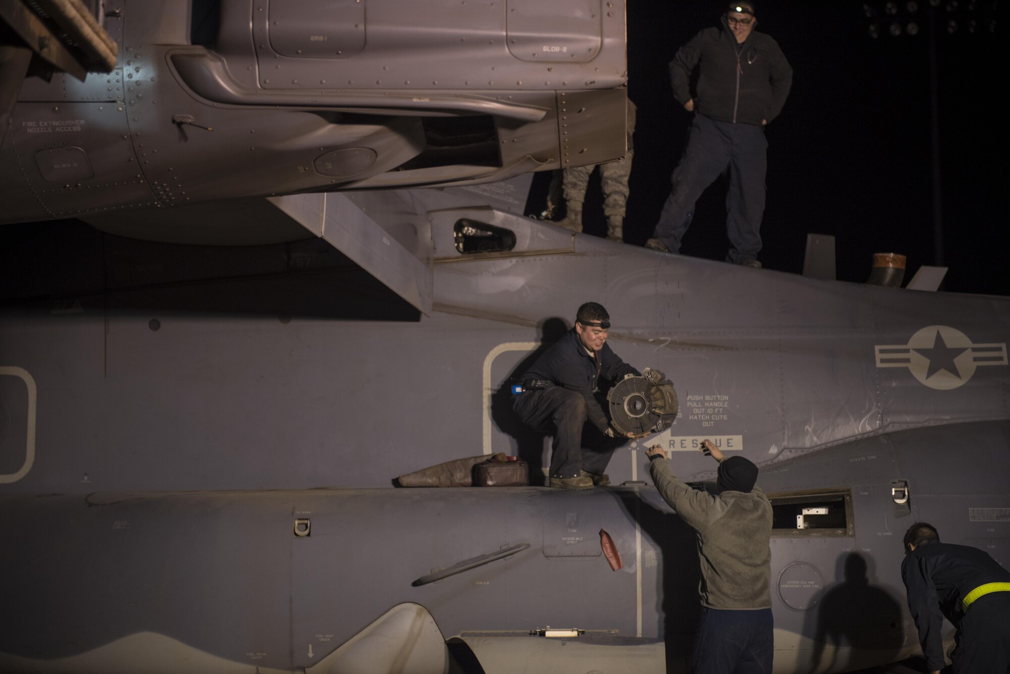 Crew chiefs with the 20th Aircraft Maintenance Unit, 727th Special Operations Aircraft Maintenance Squadron work through the night inspecting and repairing CV-22 Ospreys Oct. 18, 2016 at Cannon Air Force Base, N.M. The 20th Aircraft Maintenance Unit is one of many shops at Cannon that operates 24 hours a day, keeping the 27th Special Operations Wing ready, relevant and resilient any time, any place. (U.S. Air Force Photo by Senior Airman Shelby Kay-Fantozzi/released)