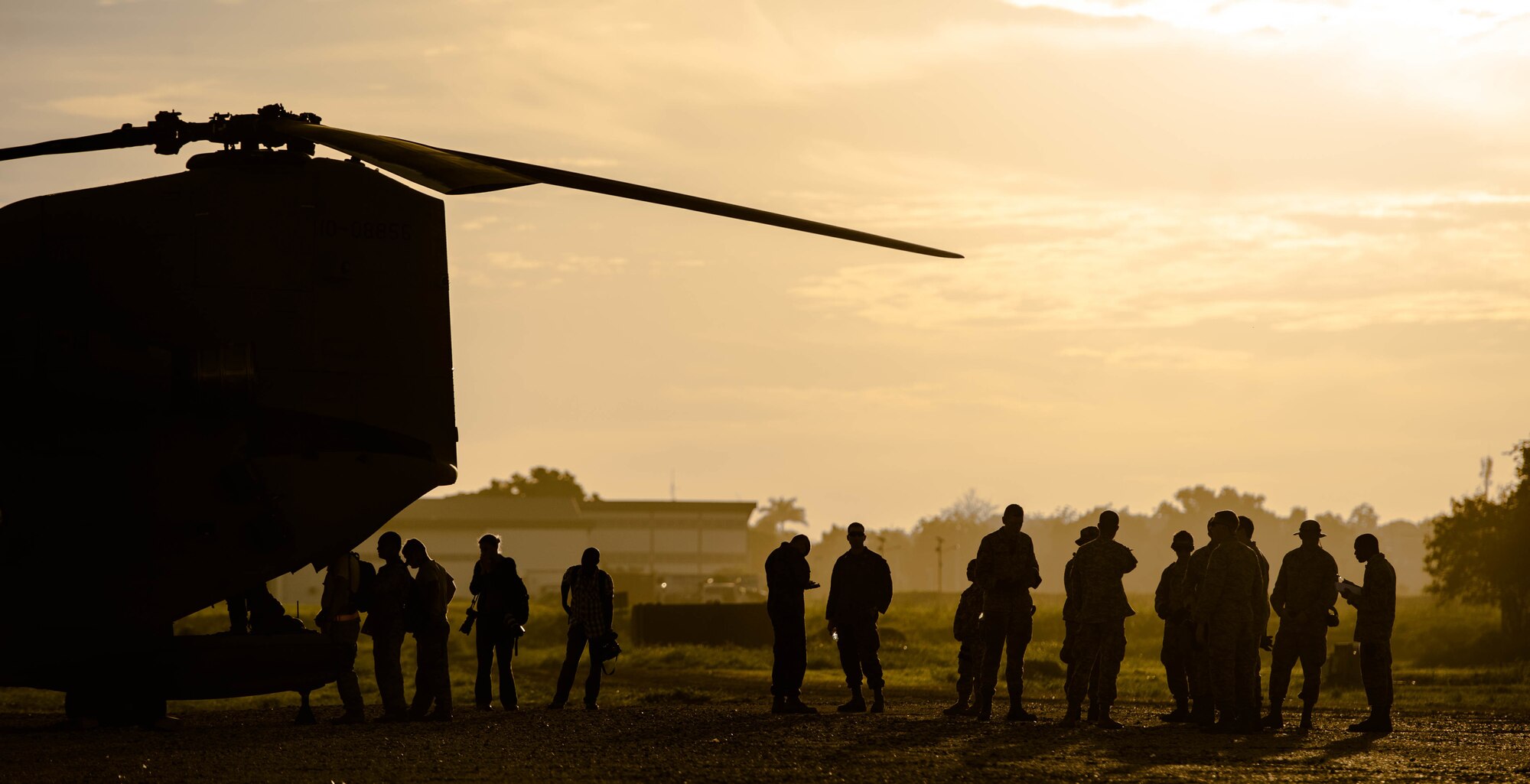 U.S. service members assigned to Joint Task Force Matthew along with photographers with Associated Press boards U.S. Army CH-47 Chinook for a USAID distribution mission Oct. 14, 2016 in Port-au-Prince, Haiti. JTF Matthew was a U.S. Southern Command lead humanitarian assistance, disaster relief effort in Haiti following Hurricane Matthew. Matthew was a category 4 hurricane that formed in the Western Atlantic Ocean and affected Haiti, eastern Cuba, and the Bahamas before moving up the southeast coast of the United States. (U.S. Air Force photo by Staff Sgt. Paul Labbe)