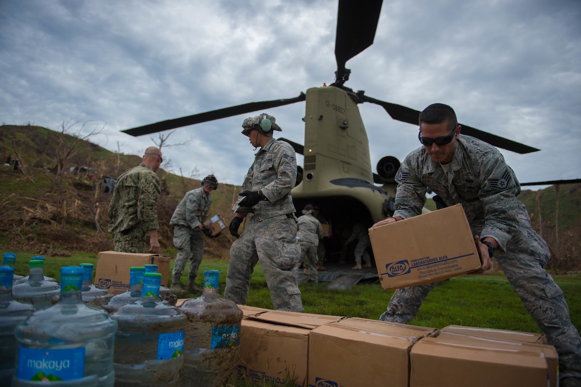 U.S. service members stack boxes of aid  which and water while off loading a U.S. Army CH-47 Chinook during an aid relief mission Oct. 14, 2016 in Anse d'Hainault, Haiti. JTF Matthew was a U.S. Southern Command lead humanitarian assistance, disaster relief effort in Haiti following Hurricane Matthew. Matthew was a category 4 hurricane that formed in the Western Atlantic Ocean and affected Haiti, eastern Cuba, and the Bahamas before moving up the southeast coast of the United States. (U.S. Air Force photo by Staff Sgt. Paul Labbe)