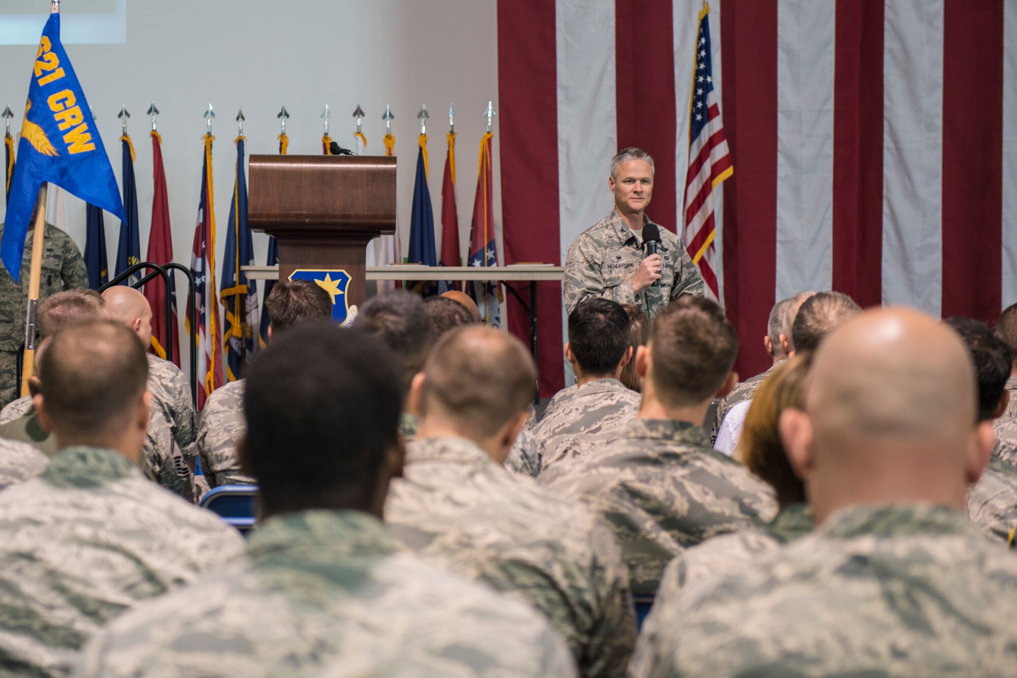 Col. Charles Henderson, 621st Contingency Response Wing commander, unveils the wing's new mission and vision statements during a Airman's call Oct. 21, 2016, at Travis Air Force Base, Calif. The wing’s new mission is to “Advise, Direct, and Project Airpower, Delivering Instruments of National Power to the Leading Edge of Global Reach.” The wing’s new vision is, “Devil Raiders…Uniquely Skilled Airmen, Building Partnerships, Strengthening the Joint Force, Mobilizing the Fight.” (U.S. Air Force photo by Staff Sgt. Robert Hicks)