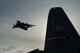 A U.S. Air Force C-17 Globemaster III aircraft passes overhead as Airman assigned to the 621st Contingency Response Wing load cargo onto a C-130J Super Hercules at Joint Base Elmendorf-Richardson, Alaska, Oct. 18, 2016. RF-A is a series of Pacific Air Forces commander-directed field training exercises for U.S. and partner nation forces, providing combined offensive counter-air, interdiction, close air support, and large force employment training in a simulated combat environment. (U.S. Air Force photo by Master Sgt. Joseph Swafford)