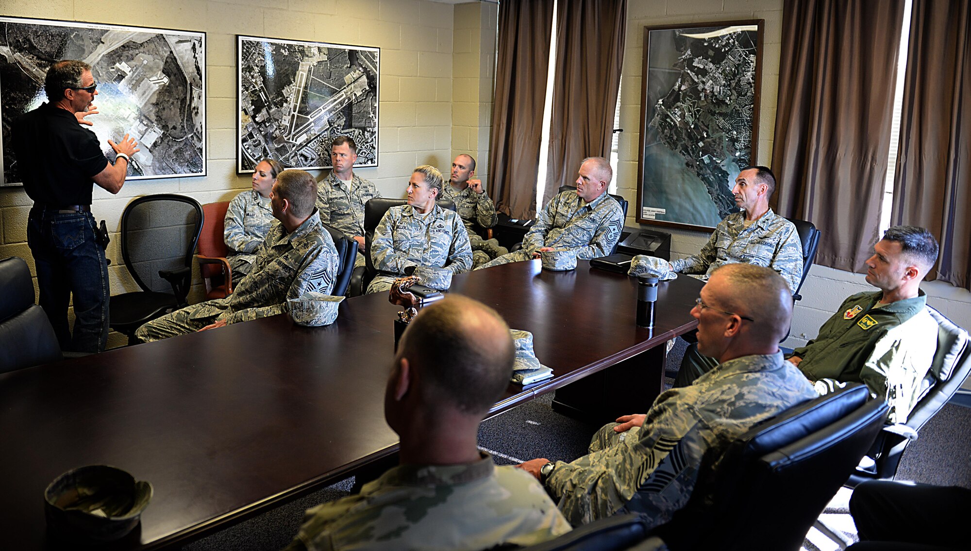 John Musser, Felker Army Airfield manager, briefs the airfield’s mission and construction plans to U.S. Air Force Maj. Gen. Scott Zobrist, 9th Air Force commander, Chief Master Sgt. Frank Batten, 9th AF command chief, and Joint Base Langley-Eustis leadership at Felker Airfield, JLBE, Va., Oct. 18. 2016. Zobrist and Batten visited various units on the joint base to gain insight on their needs to enhance mission effectiveness. (U.S. Air Force photo by Staff Sgt. Teresa J. Cleveland)