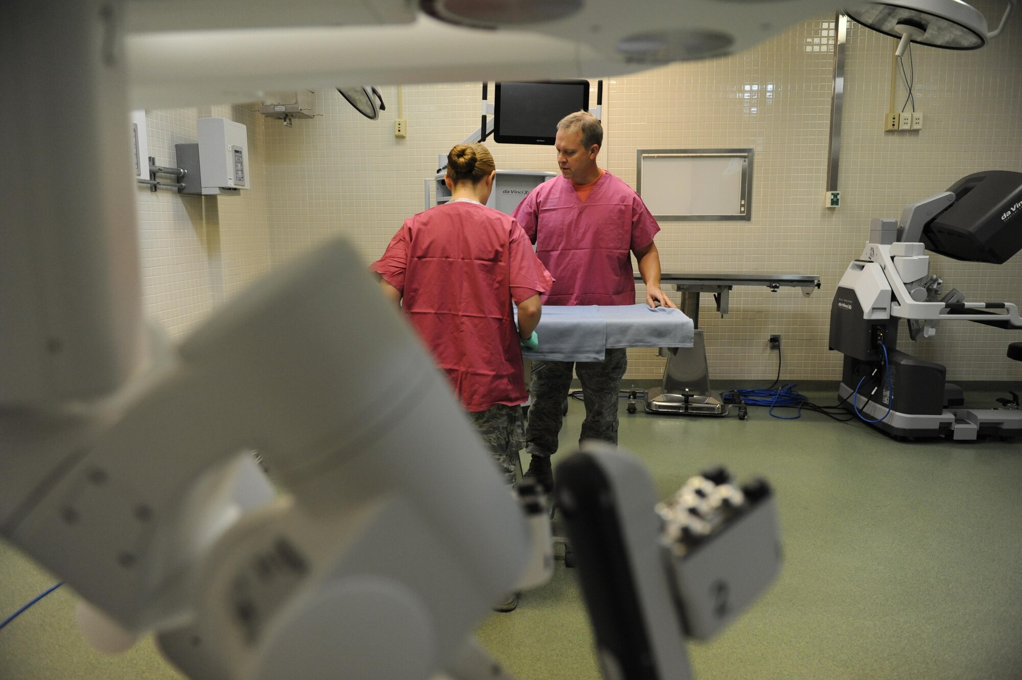 Staff Sgt. Mandy Polen, 81st Medical Support Squadron clinical research laboratory NCO in charge, and Lt. Col. (Dr.) Thomas Shaak, 81st MDSS clinical research laboratory director, prepare a table site for robotic surgical training at the Clinical Research Laboratory Oct. 21, 2016, on Keesler Air Force Base, Miss. The Keesler Medical Center recently acquired two of the da Vinci Xi which is one of the newest robotic surgical systems out there and the first of its kind for the Air Force. One surgical robot is set up as part of the Institute for Defense Robotic Surgical Education to assist surgeons in getting their official robotic surgery credentials. (U.S. Air Force photo by Kemberly Groue/Released)