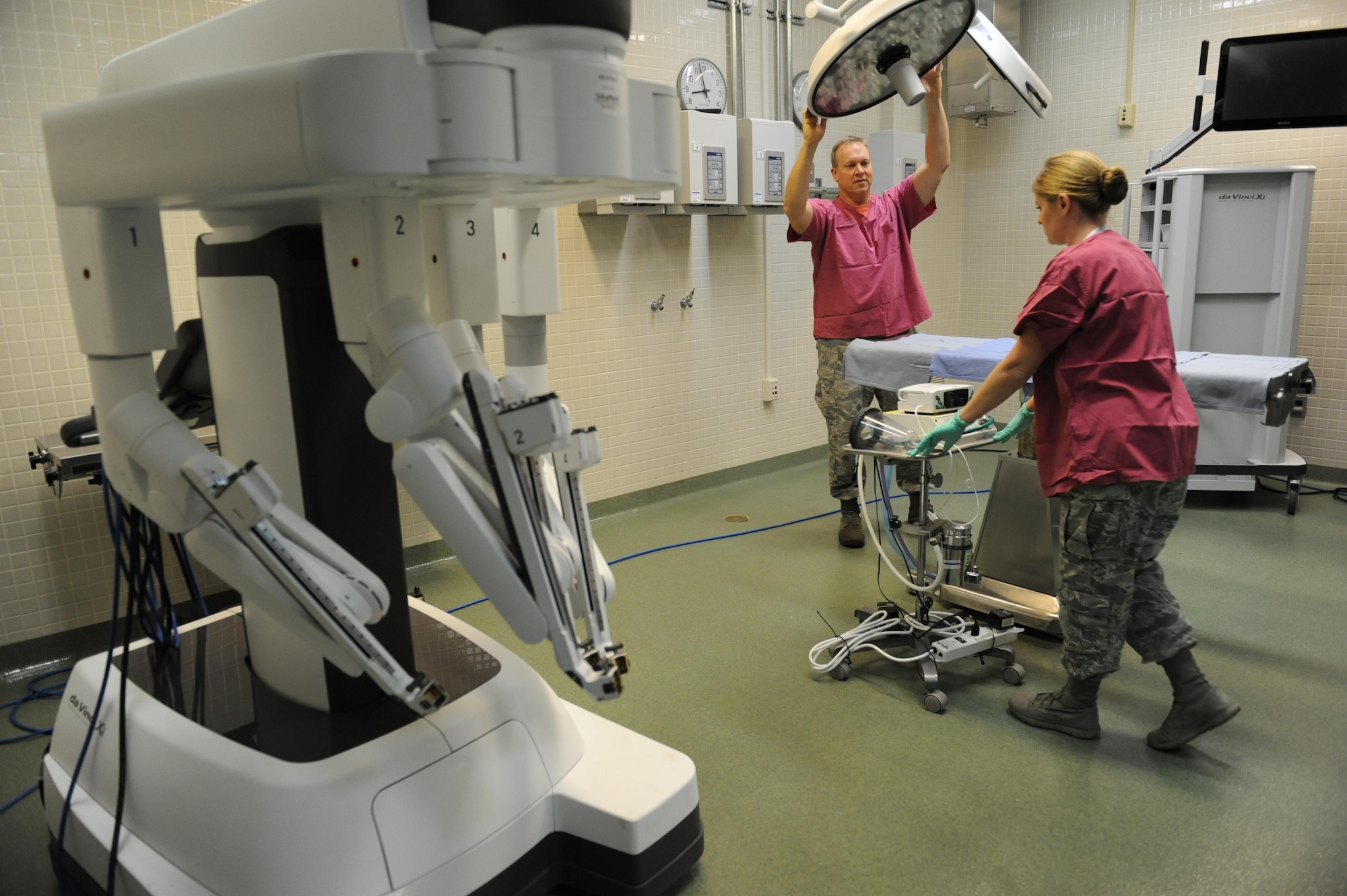 Lt. Col. (Dr.) Thomas Shaak , 81st Medical Support Squadron clinical research laboratory director, and Staff Sgt. Mandy Polen, 81st MDSS clinical research laboratory NCO in charge, prepare a table site for robotic surgical training at the Clinical Research Laboratory Oct. 21, 2016, on Keesler Air Force Base, Miss. The Keesler Medical Center recently acquired two of the da Vinci Xi which is one of the newest robotic surgical systems out there and the first of its kind for the Air Force. One surgical robot is set up as part of the Institute for Defense Robotic Surgical Education to assist surgeons in getting their official robotic surgery credentials. (U.S. Air Force photo by Kemberly Groue/Released)