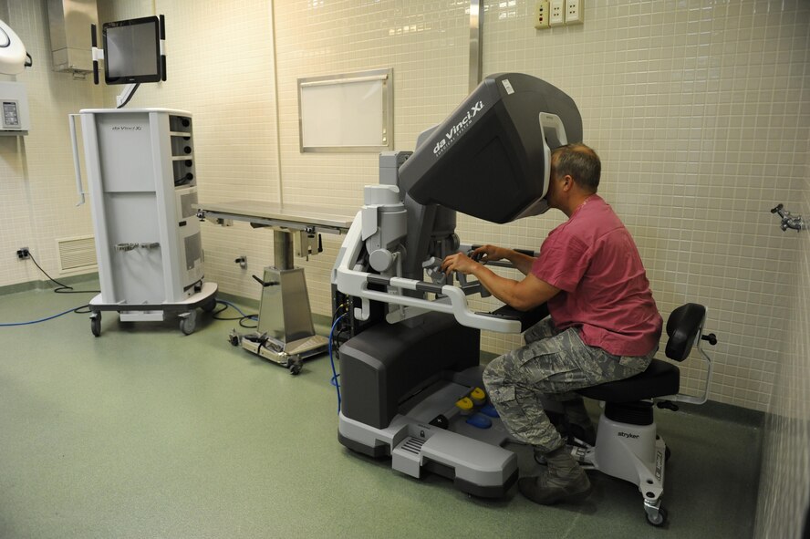 Lt. Col. (Dr.) Thomas Shaak , 81st Medical Support Squadron clinical research laboratory director, uses a 3-D automated control unit to perform robotic surgical simulation training at the Clinical Research Laboratory Oct. 21, 2016, on Keesler Air Force Base, Miss. The Keesler Medical Center recently acquired two of the da Vinci Xi which is one of the newest robotic surgical systems out there and the first of its kind for the Air Force. One surgical robot is set up as part of the Institute for Defense Robotic Surgical Education to assist surgeons in getting their official robotic surgery credentials. (U.S. Air Force photo by Kemberly Groue/Released)