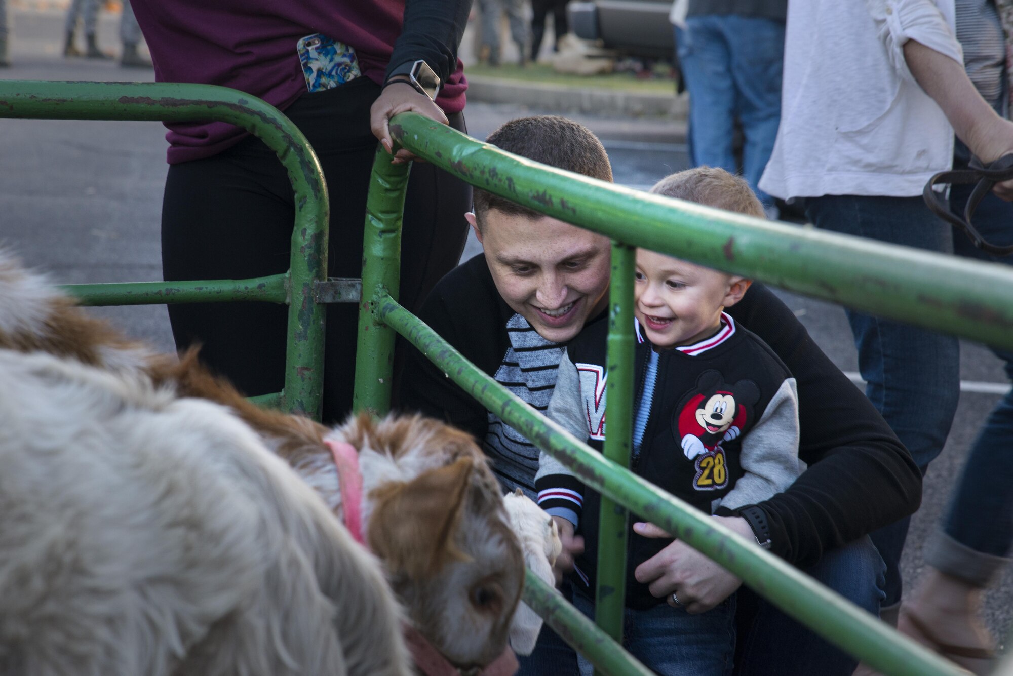 A Team Scott family feed farm animals during the Fall Fest October 21, 2016 at Scott Air Force Base, Illinois. The Festival offered games and activities for children such as balloon animals,petting zoo, pumpkin painting and face painting. (U.S. Air Force photo by Airman 1st Class Gwendalyn Smith)