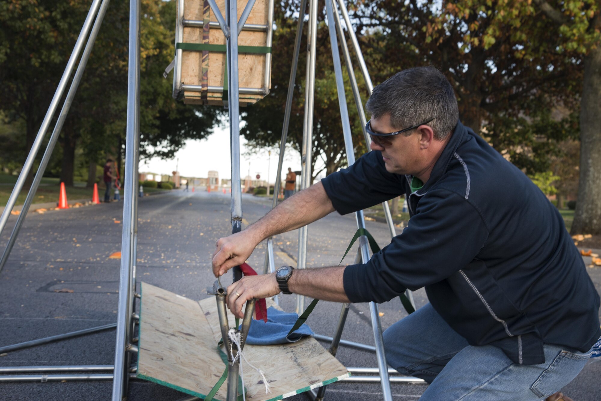 Senior MSgt. Adam Carr, 375th Comptroller Squadron superintendent, prepares his teams trebuchet for a pumkin launching contest during the Fall Fest October 21, 2016 at Scott Air Force Base, Illinois. Teams from around base built trebuchets and competed to see who could launch a pumpkin the furthest.(U.S. Air Force photo by Airman 1st Class Gwendalyn Smith)
