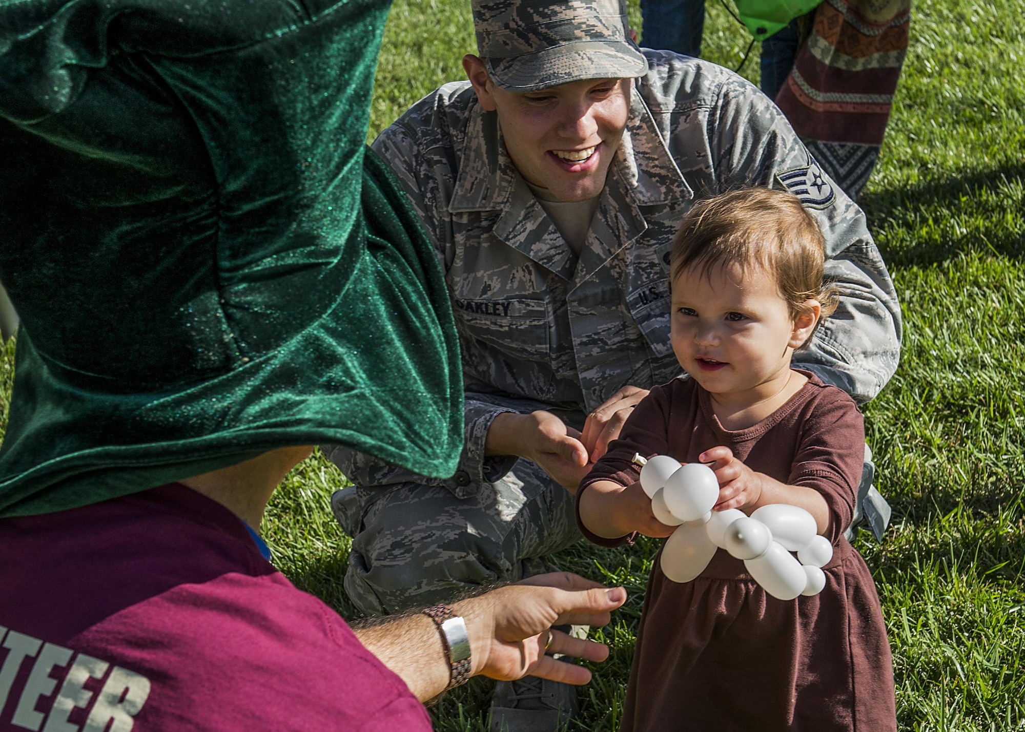 A child receives a balloon animal from a volunteer during the second annual Harvest Festival at Scott Air Force Base, Ill. on Oct. 21, 2016. Children were able to participate in multiple different games and activities at the Harvest Festival. (U.S. Air Force Photo by Senior Airman Megan Friedl)