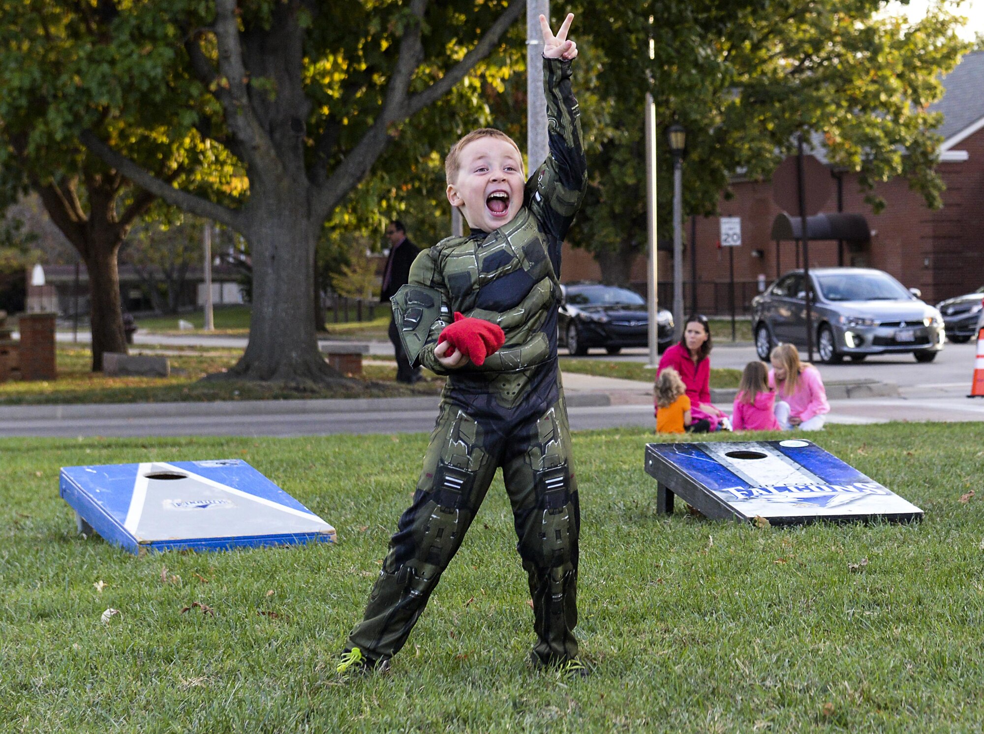 A child celebrates as he plays corn hole at the Harvest Festival at Scott Air Force Base, Ill. on Oct. 21, 2016. Airmen and their families participated in games, a petting zoo, pumpkin picking, a bake off and a chili cook off. (U.S. Air Force Photo by Senior Airman Megan Friedl)