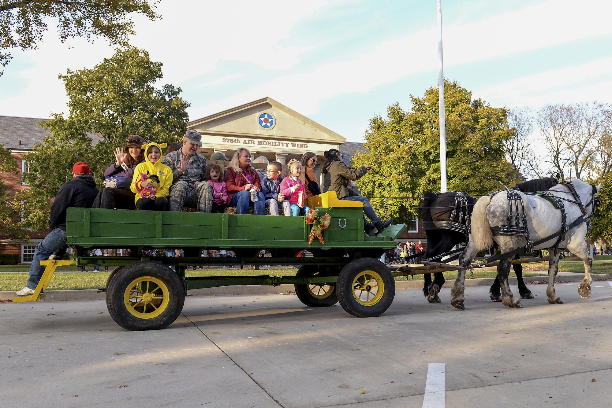 Airmen and their families take part in a hayride during the second annual Harvest Festival that is hosted by the Scott Air Force Base Chapel at Scott Air Force Base, Ill. on Oct. 21, 2016. The Harvest Festival offered free food, live music, games and activities for families to participate in. (U.S. Air Force Photo by Senior Airman Megan Friedl)