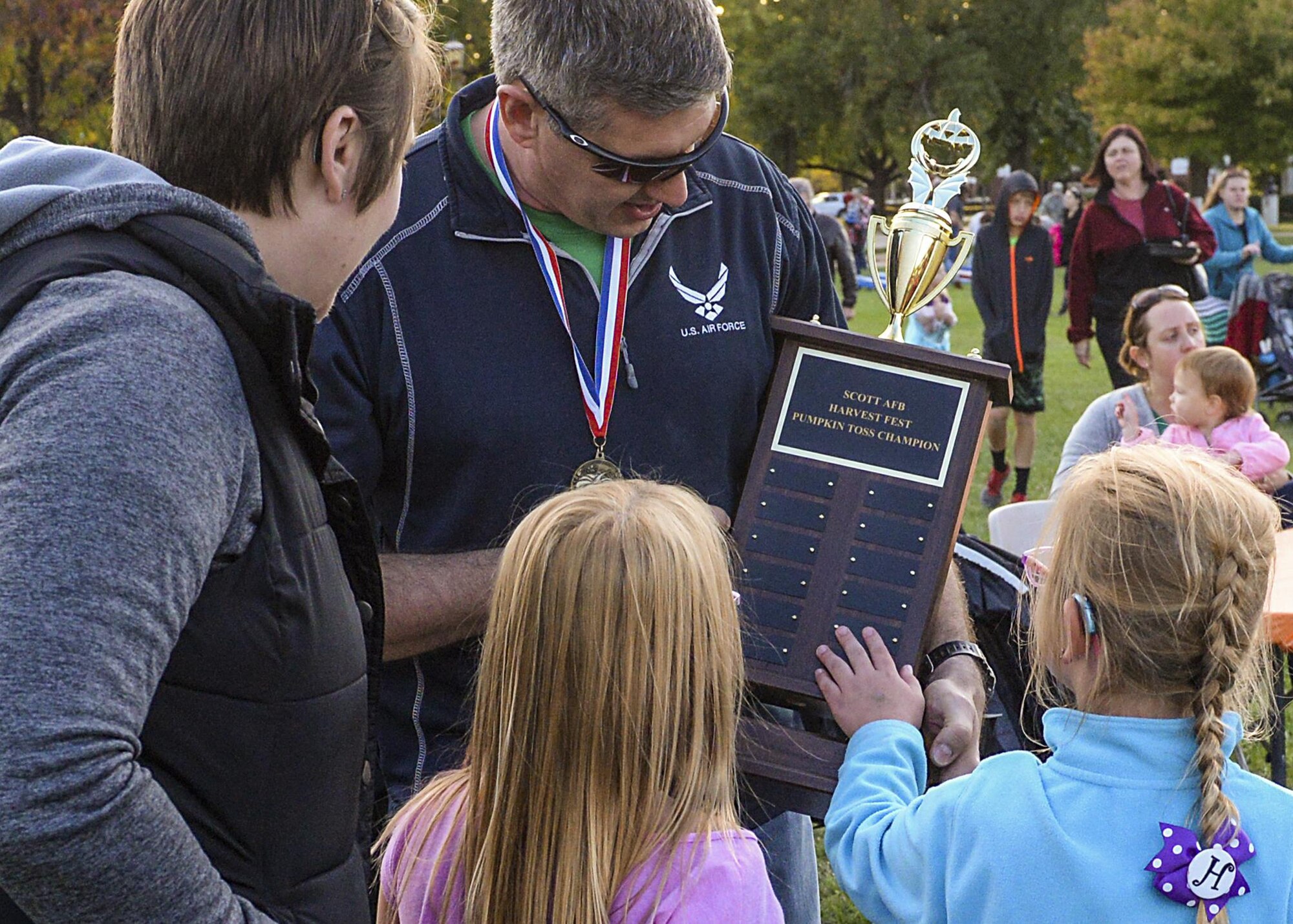 Senior Master Sgt. Adam Carr, 375th Comptroller Squadron Superintendent, shows his trophy for winning the Harvest Festival Pumpkin Toss Trebuchet at Scott Air Force Base, Ill. on Oct. 21, 2016. The Scott Air Force Base Chapel hosted their second annual Harvest Festival for Airmen and their families to enjoy. (U.S. Air Force Photo by Senior Airman Megan Friedl)