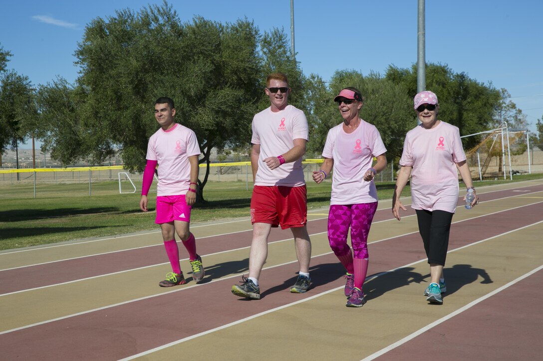 Marine Corps Air Ground Combat Center patrons participate in the Officer Spouse’s Club’s third annual Pink Breast Cancer Awareness Walk do laps around the track at Felix Field aboard the Marine Corps Air Ground Combat Center, Twentynine Palms, Calif., Oct. 14, 2016. OSC hosted the walk to raise awareness and money for breast cancer research. (Official Marine Corps photo by Lance Cpl. Dave Flores/Released)