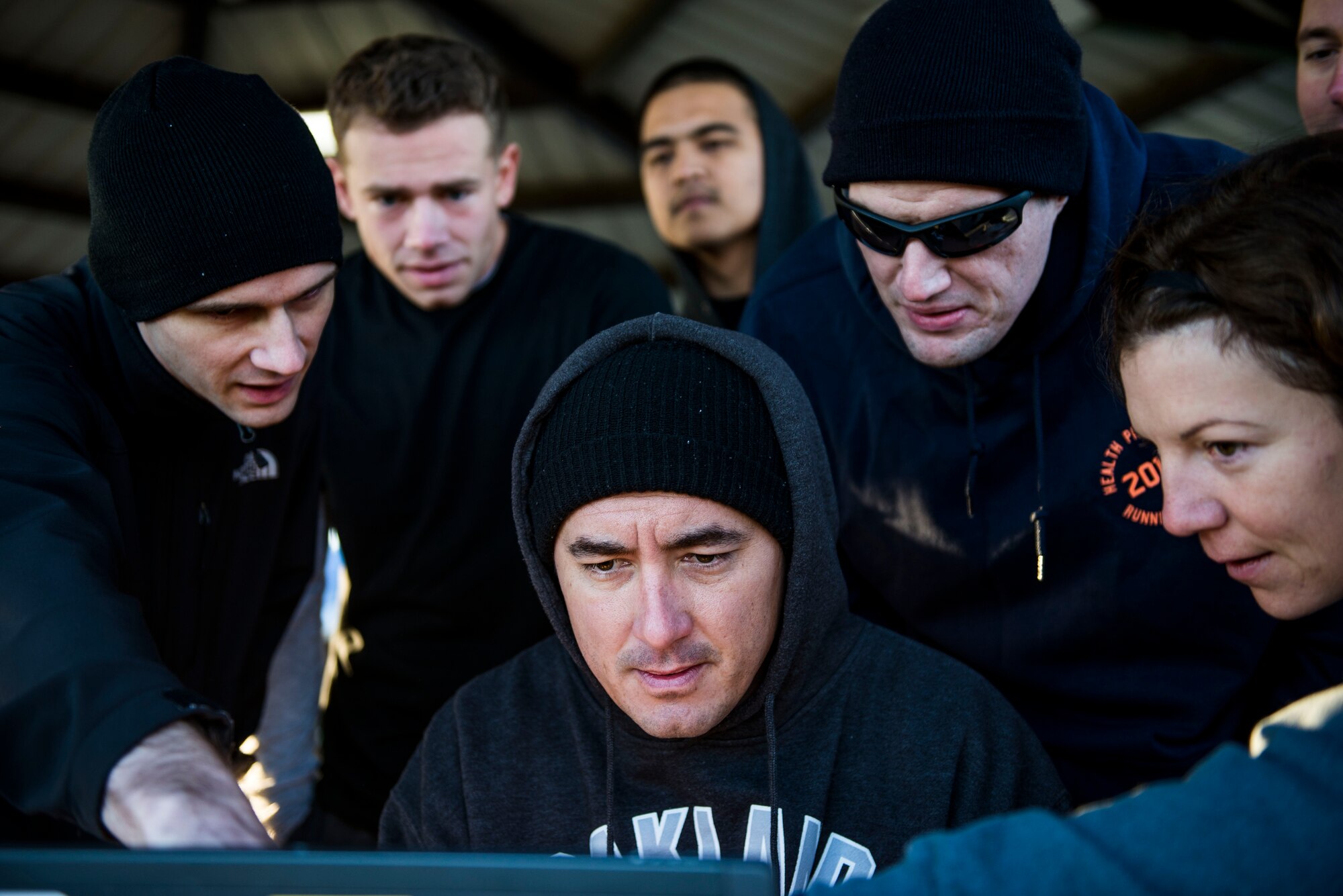 Members of the 835th Cyberspace Operations Squadron work together to figure out one of three cyber challenges during the Communication Fitness Challenge, Scott Air Force Base, Ill., Oct. 21, 2016. The 375th Communications Group hosted its first ever Communication Fitness Challenge, where cyber units on Scott Air Force Base competed against each other in various challenges to test their knowledge of communications, Oct. 21, 2016. The 38th Cyberspace Squadron, 835th Cyberspace Operations Squadron, Air Force Network Integration Center, Cyberspace Support Squadron, Transportation Command, 375th Communications Squadron, 375th Communications Support Squadron, and Defense Information Systems Agency took part in the five-phase challenge, which included a capture the flag, ultimate Frisbee, and numerous mental contests.   DISA took first place, 375th CS took second, and 375th CSPTS took third. (U.S. Air Force photo by Staff Sgt. Jodi Martinez)