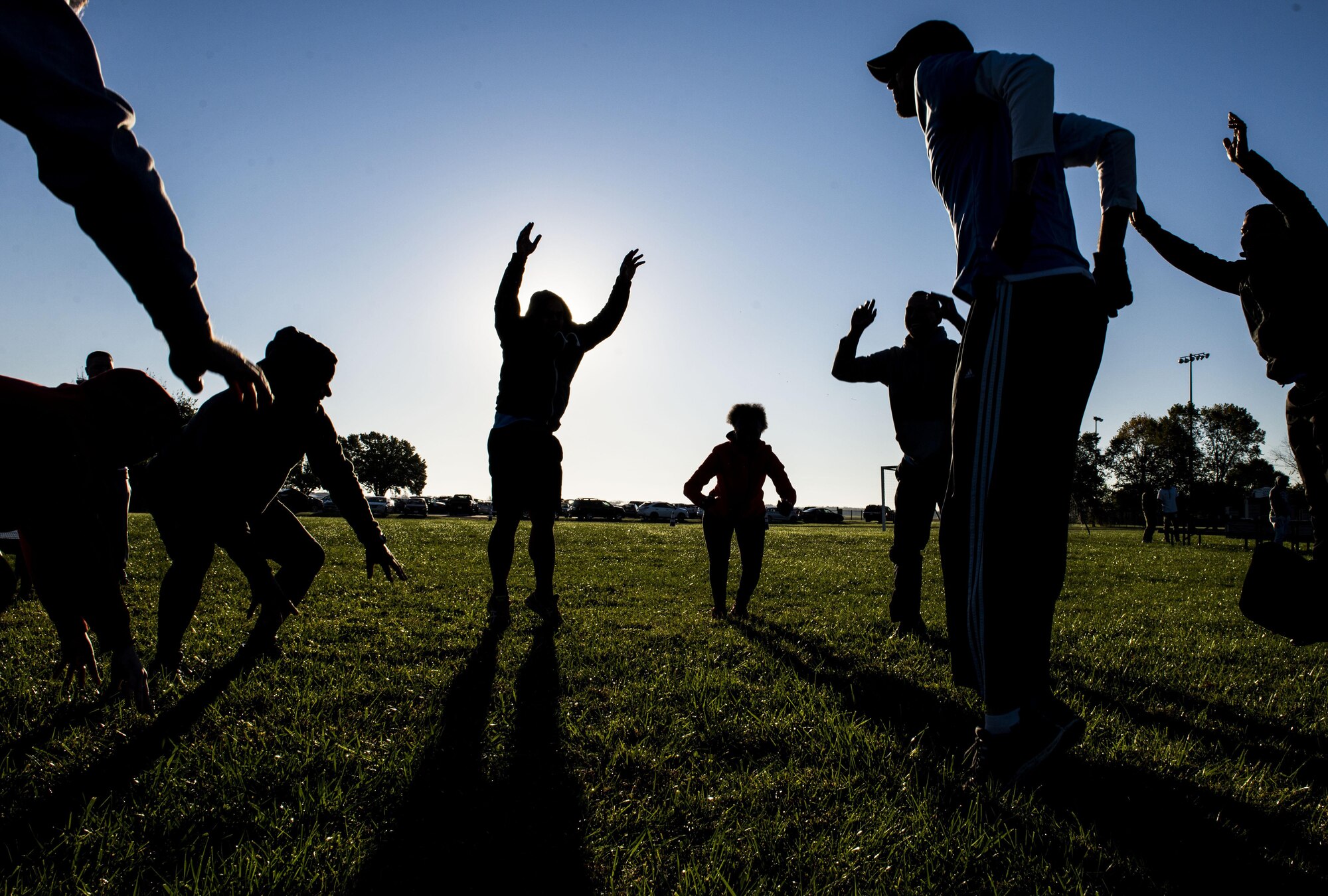 Participants complete 30 burpees during the Communication Fitness Challenge, Scott Air Force Base, Ill., Oct. 21, 2016. The 375th Communications Group hosted its first ever Communication Fitness Challenge, where cyber units on Scott Air Force Base competed against each other in various challenges to test their knowledge of communications, Oct. 21, 2016. The 38th Cyberspace Squadron, 835th Cyberspace Operations Squadron, Air Force Network Integration Center, Cyberspace Support Squadron, Transportation Command, 375th Communications Squadron, 375th Communications Support Squadron, and Defense Information Systems Agency took part in the five-phase challenge, which included a capture the flag, ultimate Frisbee, and numerous mental contests.   DISA took first place, 375th CS took second, and 375th CSPTS took third. (U.S. Air Force photo by Staff Sgt. Jodi Martinez)