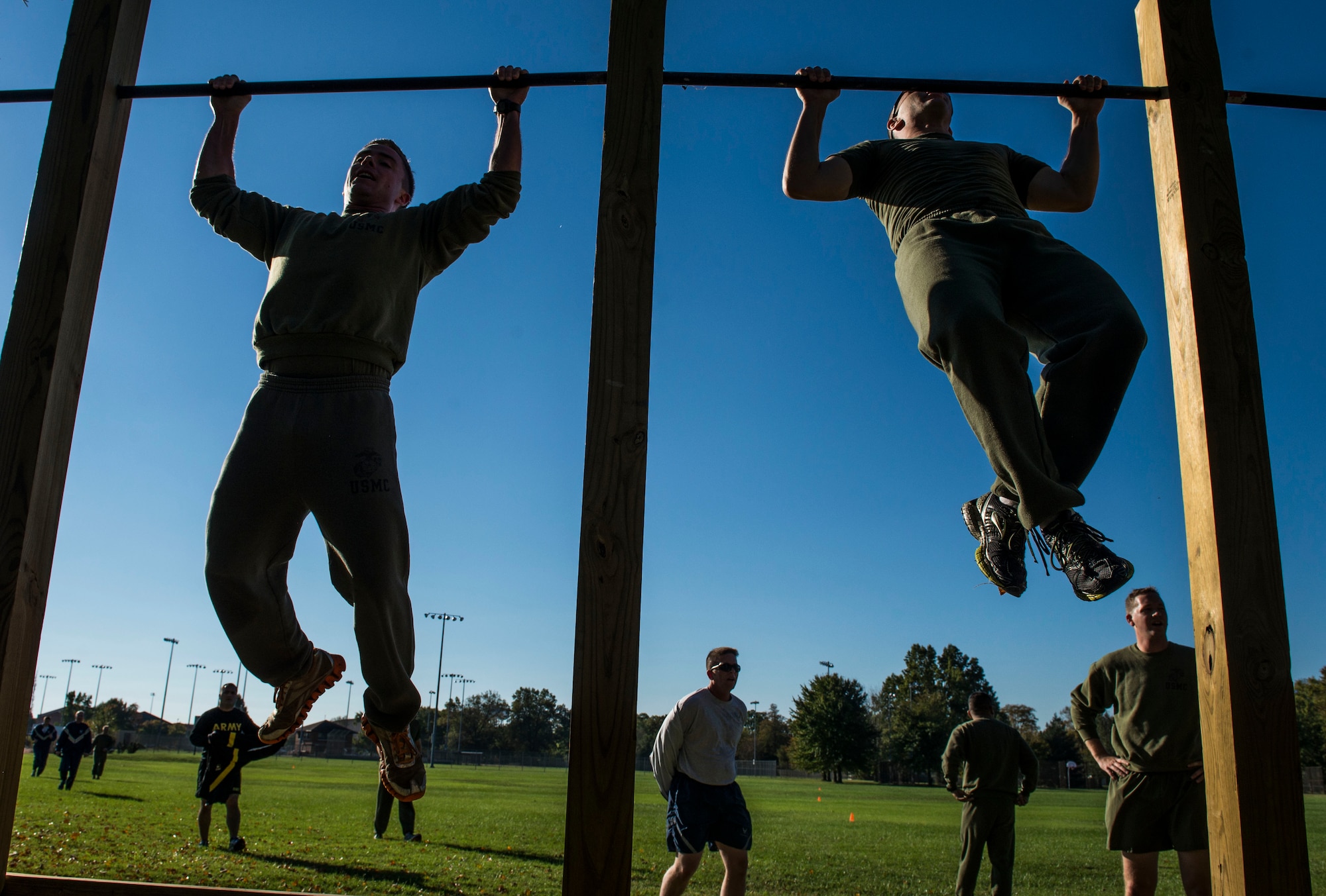 Marines with the Defense Information Systems Agency work together to complete 100 pull-ups as part of their fitness challenge, Scott Air Force Base, Ill., Oct. 21, 2016. The 375th Communications Group hosted its first ever Communication Fitness Challenge, where cyber units on Scott Air Force Base competed against each other in various challenges to test their knowledge of communications, Oct. 21, 2016. The 38th Cyberspace Squadron, 835th Cyberspace Operations Squadron, Air Force Network Integration Center, Cyberspace Support Squadron, Transportation Command, 375th Communications Squadron, 375th Communications Support Squadron, and Defense Information Systems Agency took part in the five-phase challenge, which included a capture the flag, ultimate Frisbee, and numerous mental contests.   DISA took first place, 375th CS took second, and 375th CSPTS took third. (U.S. Air Force photo by Staff Sgt. Jodi Martinez)